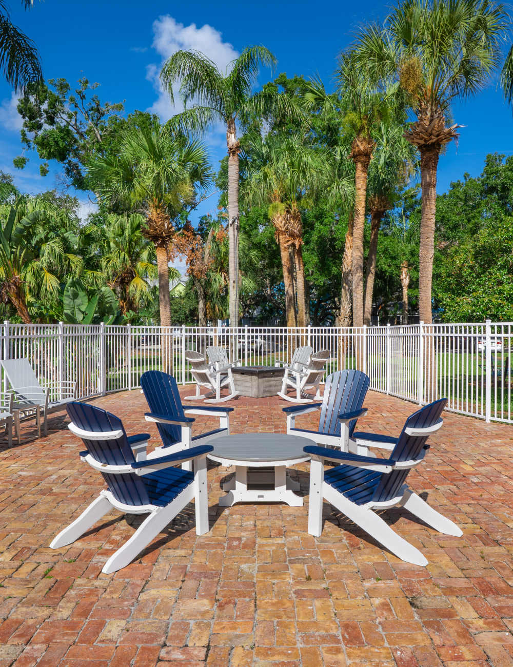 Outdoor fireside seating by the community swimming pool at Mode at Ballast Point in Tampa, Florida