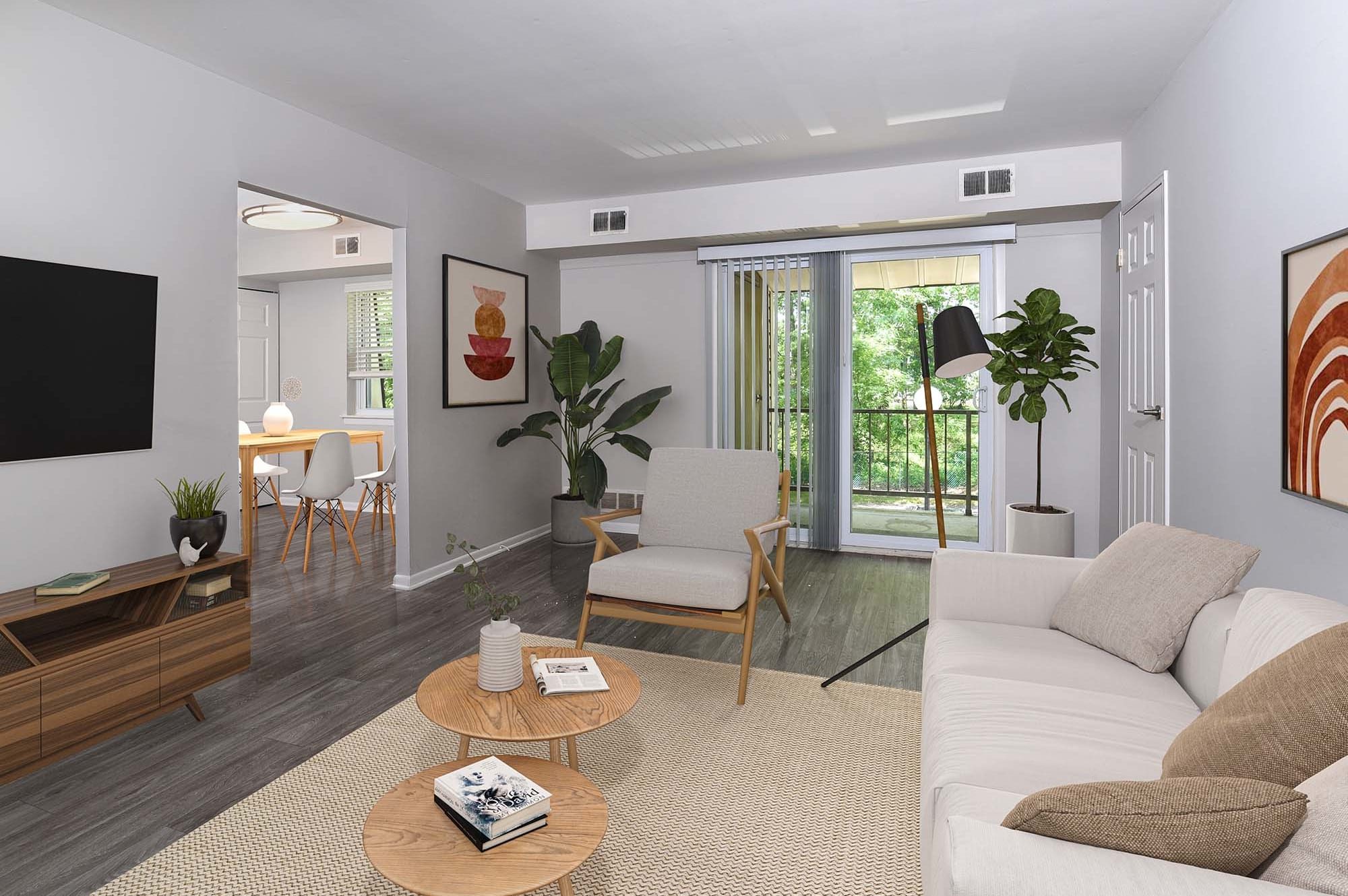 Model living room with dining room off to the back left sliding glass doors to the balcony at The Nolan, Morrisville, Pennsylvania