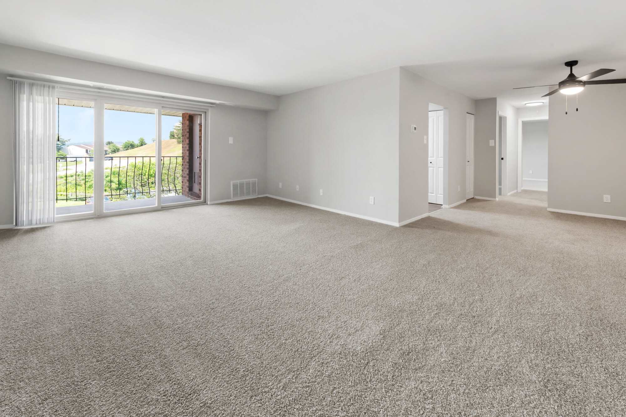 living room with sliding glass doors to balcony at Greenspring in York, Pennsylvania