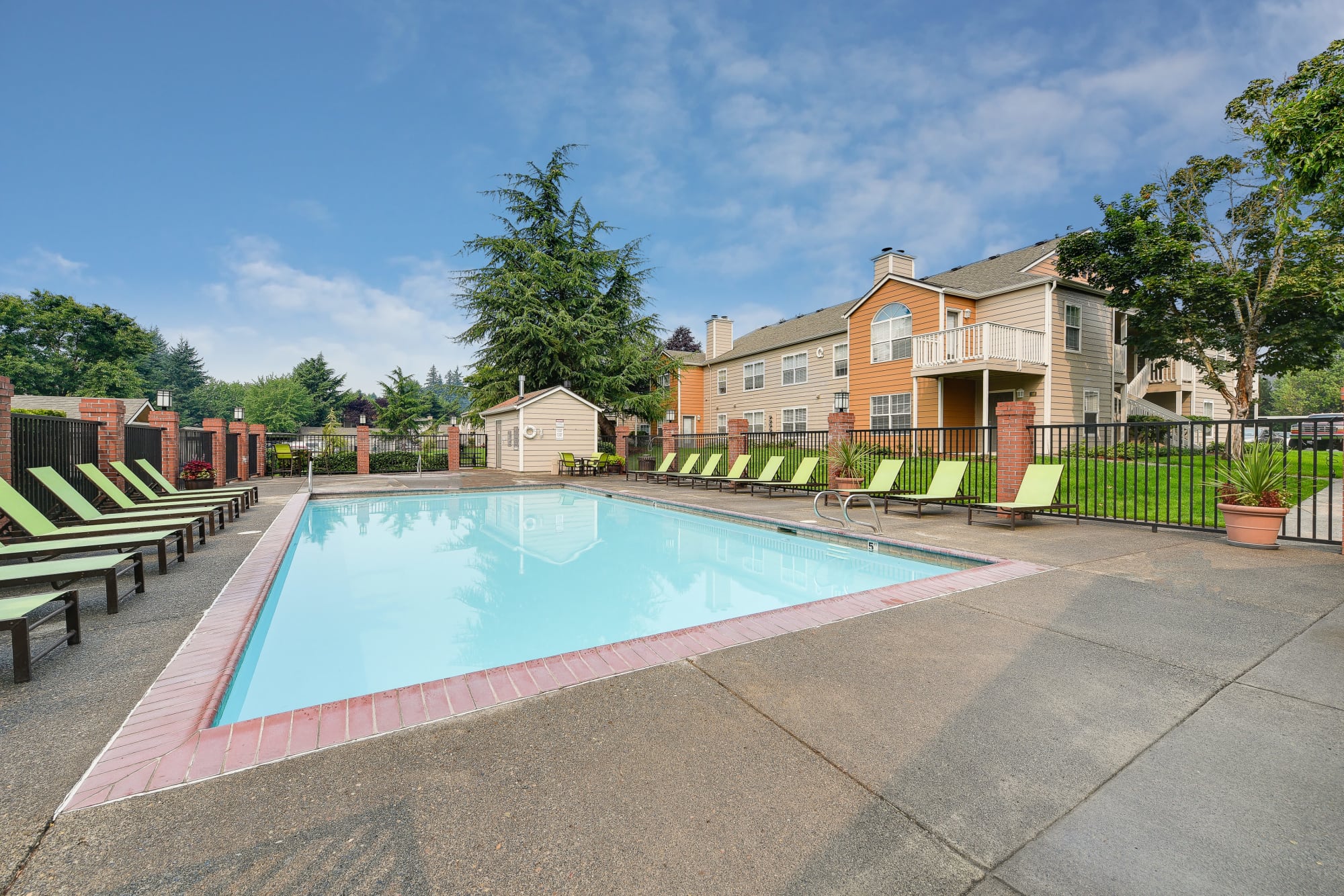 Lounge chairs by the pool at Carriage Park Apartments in Vancouver, Washington