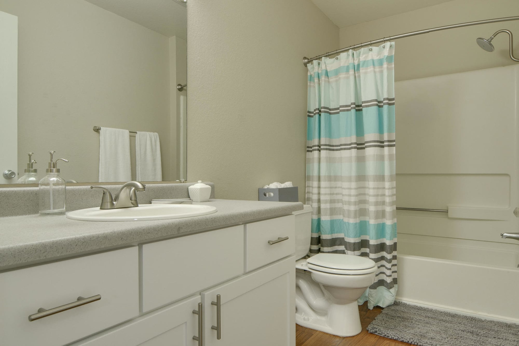 Renovated bathroom with white cabinets at Carriage House Apartments in Vancouver, Washington