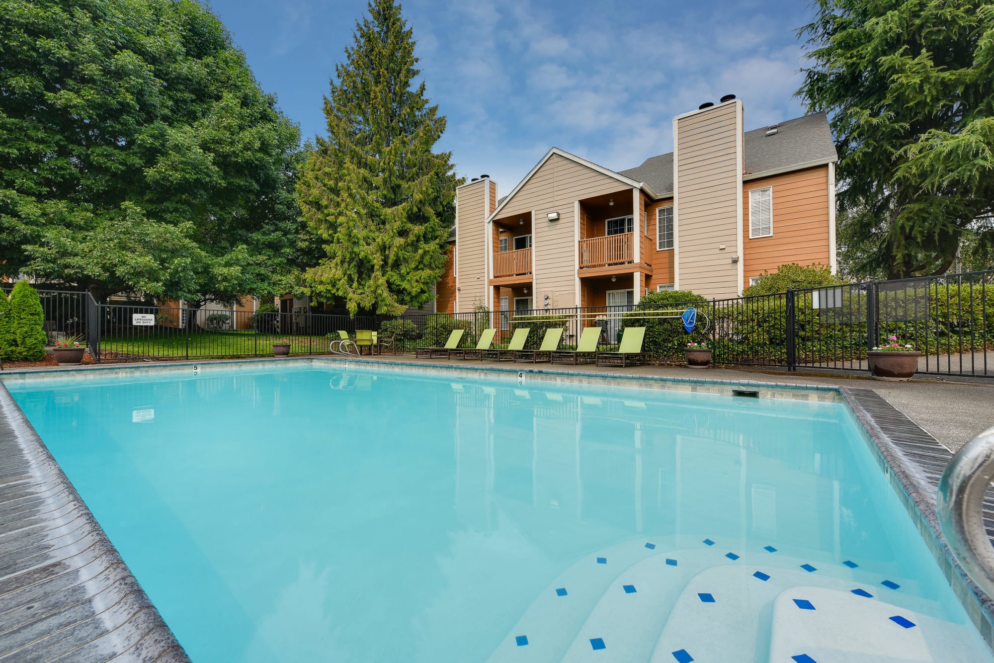 The bright blue pool at Carriage House Apartments in Vancouver, Washington