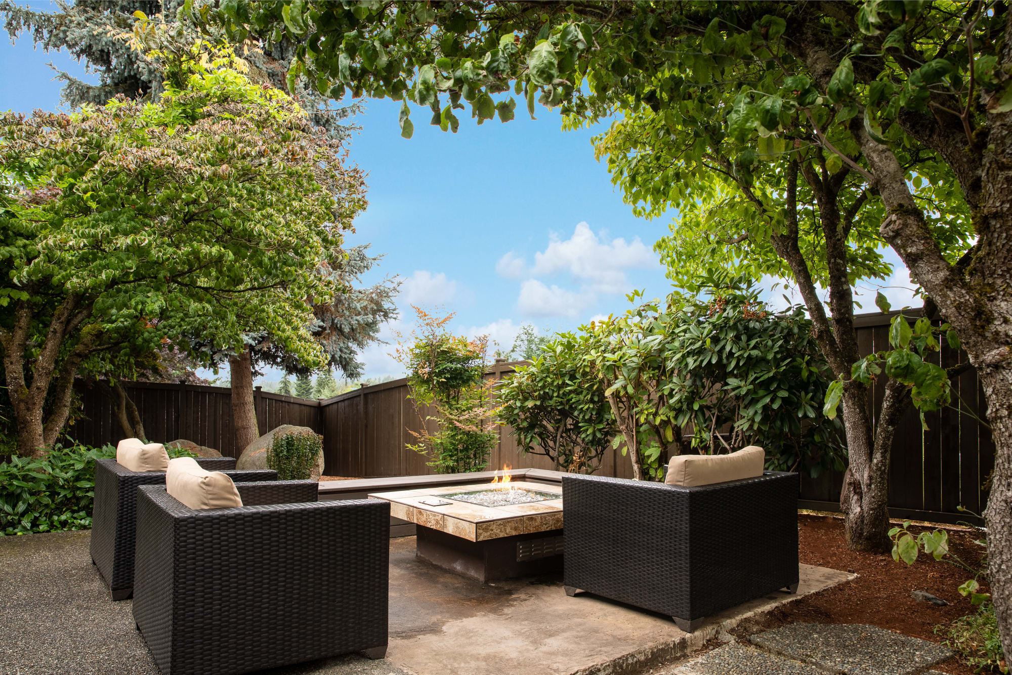Common area courtyard fire pit lounge at Latitude Apartments in Everett, Washington
