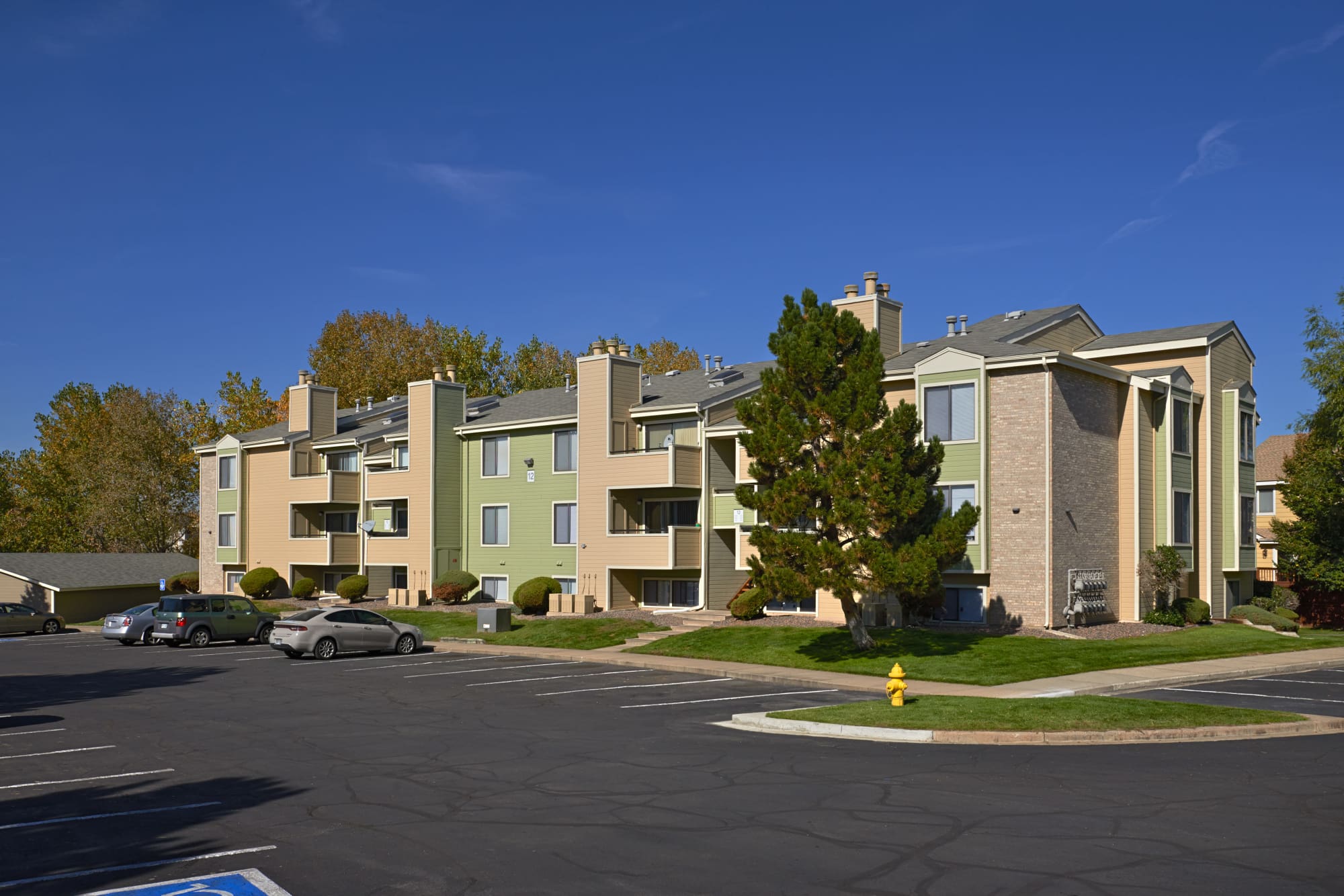 Exterior view of Alton Green Apartments on a sunny day in Denver, Colorado