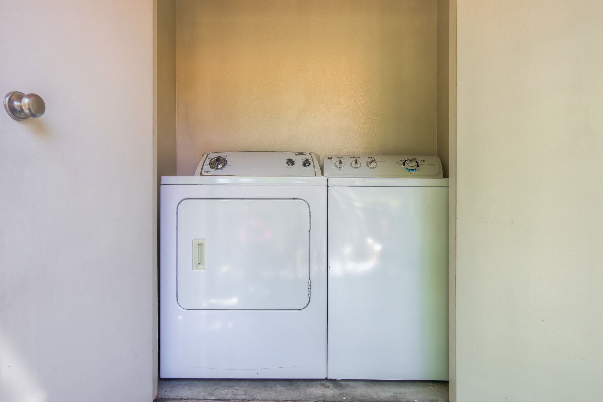 Side-by-side washer and dryer at Tuscany Village Apartments in Ontario, California