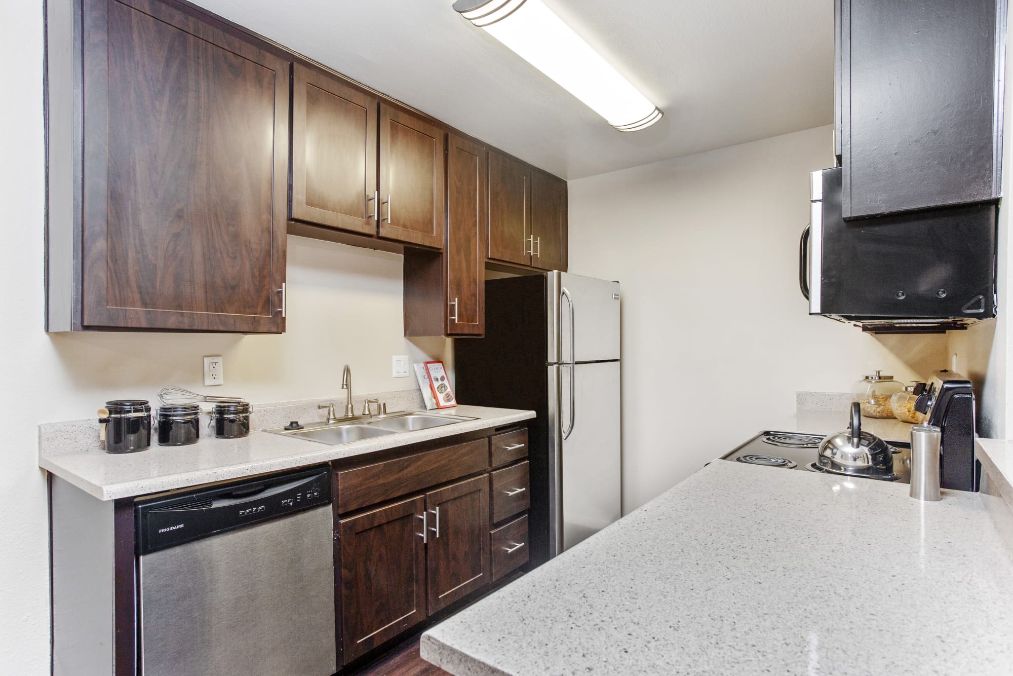 Fully equipped kitchen with stainless steel appliances at Shadow Ridge Apartments in Oceanside, California