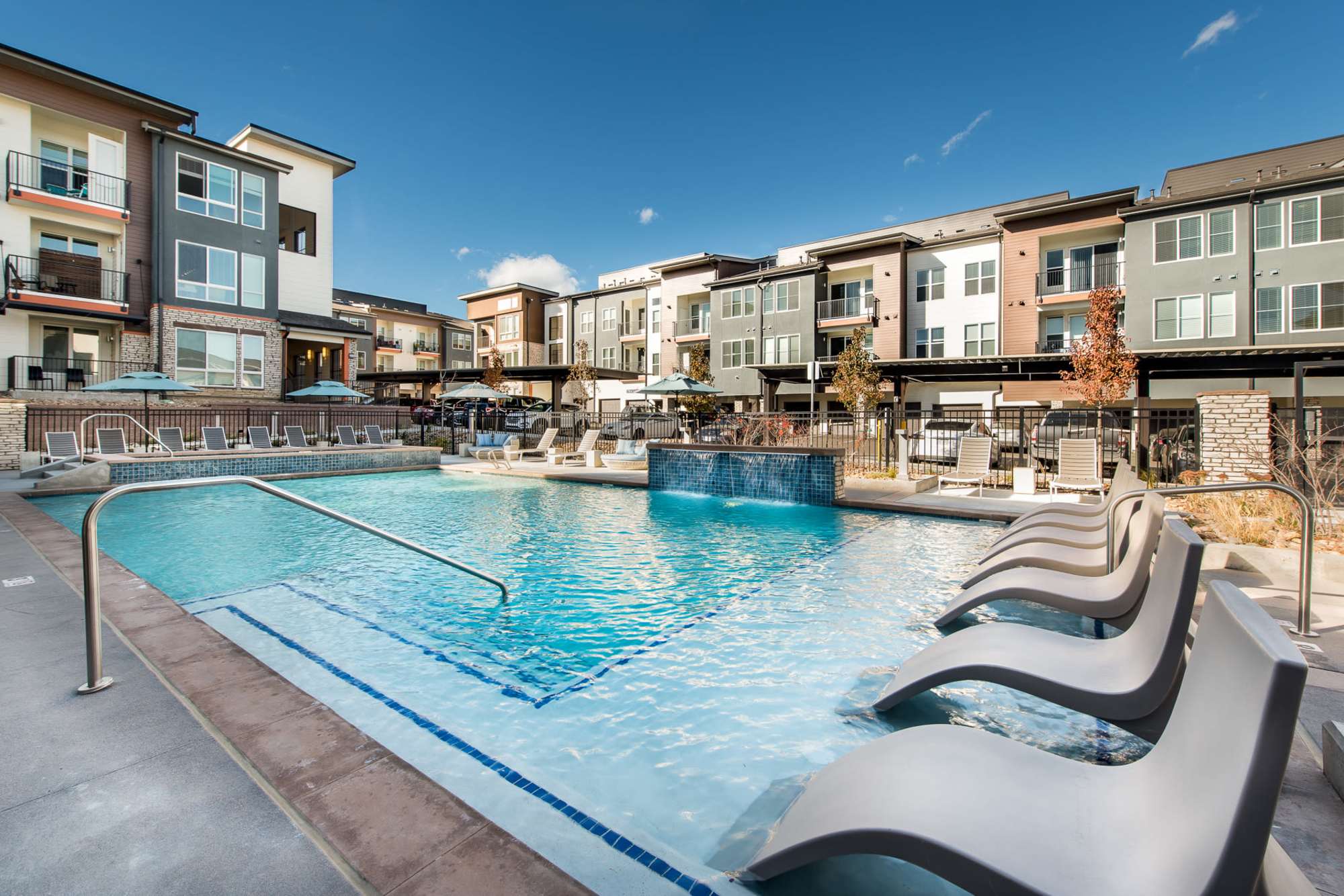 Swimming pool with lounge chairs at Elevate in Englewood, Colorado