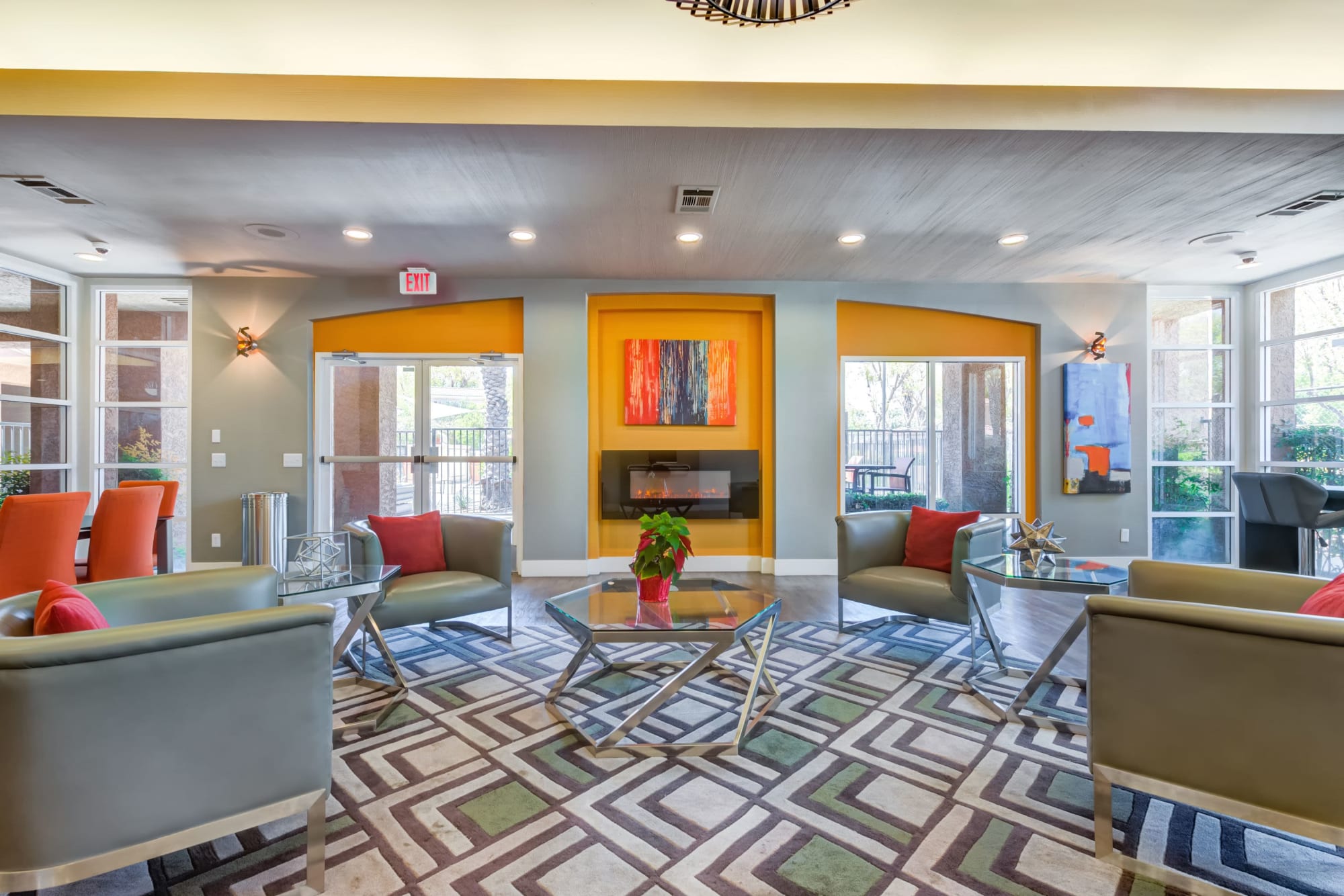 Clubhouse seating area with couches and a fireplace at Tuscany Village Apartments in Ontario, California