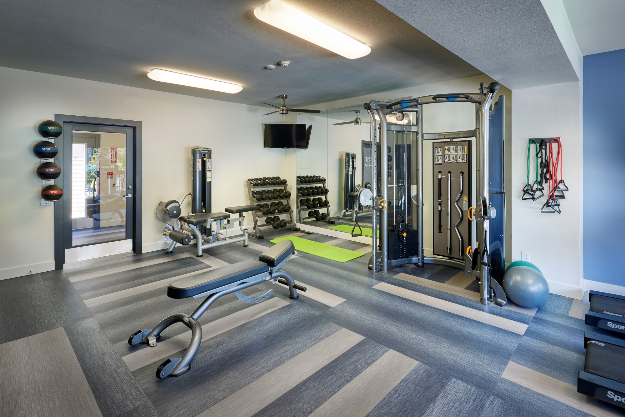 Fully equipped fitness center with weights and machines at Arapahoe Club Apartments in Denver, Colorado