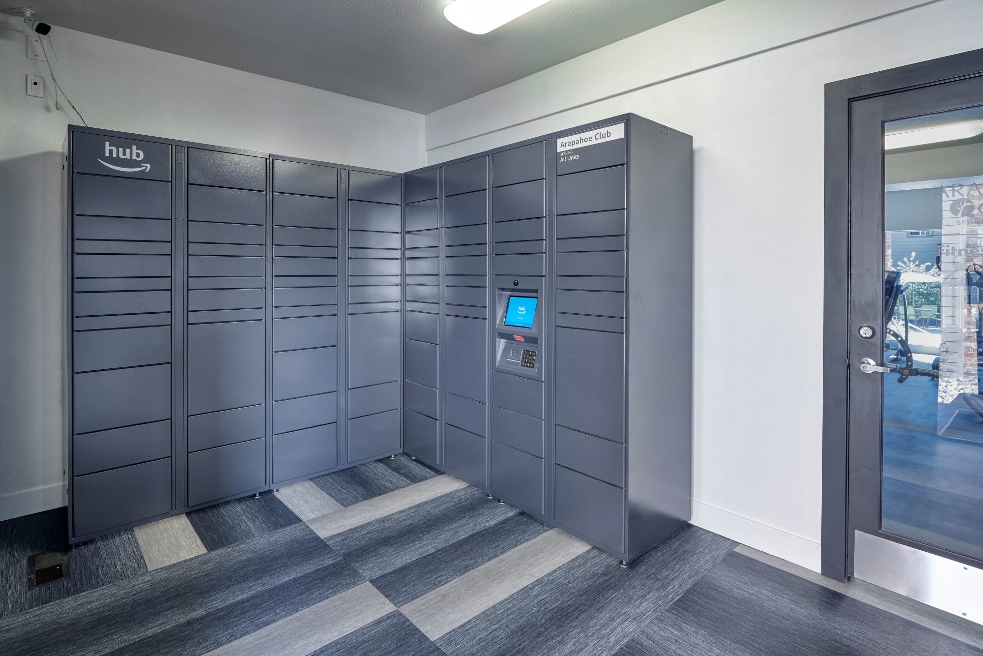 Package lockers including an Amazon hub at Arapahoe Club Apartments in Denver, Colorado