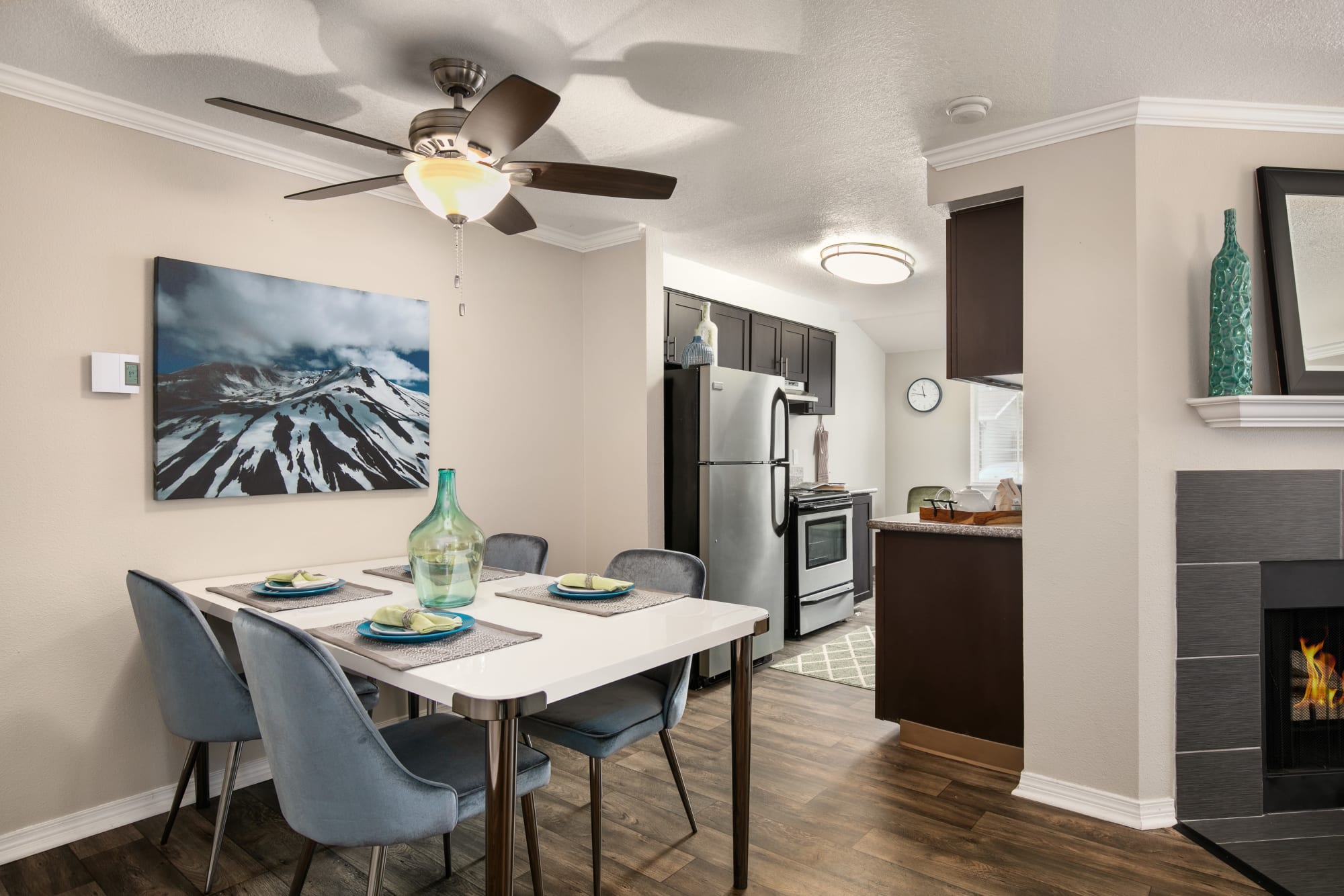 Dining room, kitchen, and a fireplace at Walnut Grove Landing Apartments in Vancouver, Washington