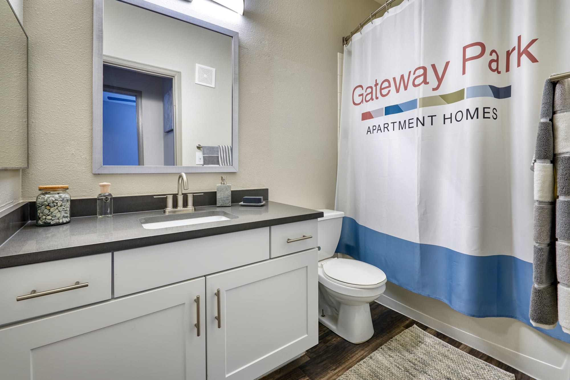A renovated bathroom with white cabinetry at Gateway Park Apartments in Denver, Colorado