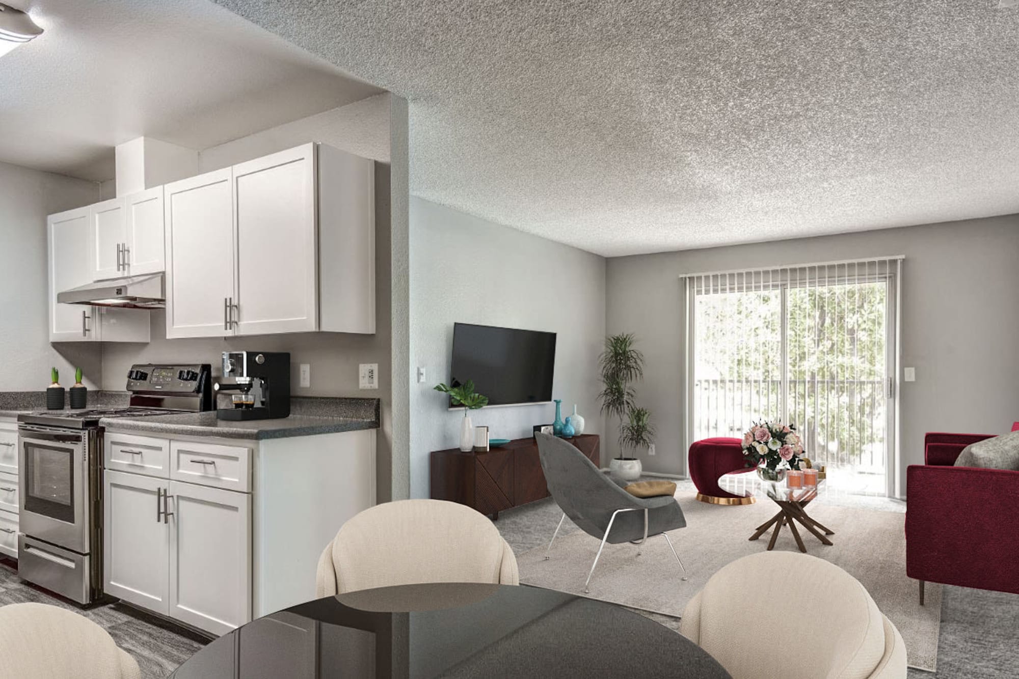 Kitchen with a view of the living room at The Woodlands Apartments in Sacramento, California