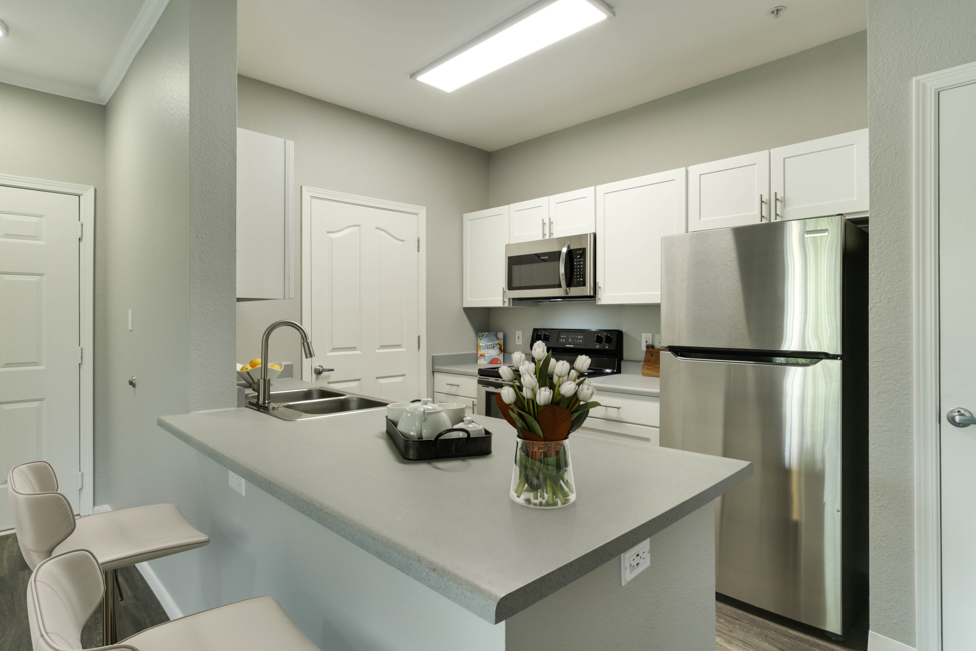 Renovated kitchen with white cabinets at The Grove at Orenco Station in Hillsboro, Oregon