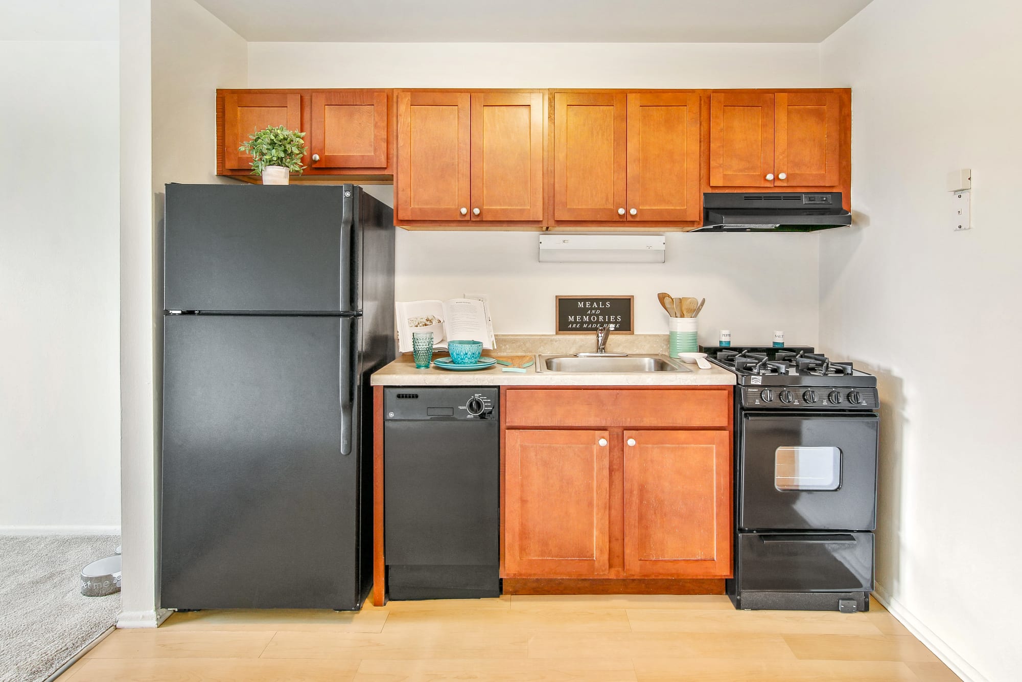 An apartment kitchen with oak cabinets at Riverstone Apartments in Bolingbrook, Illinois