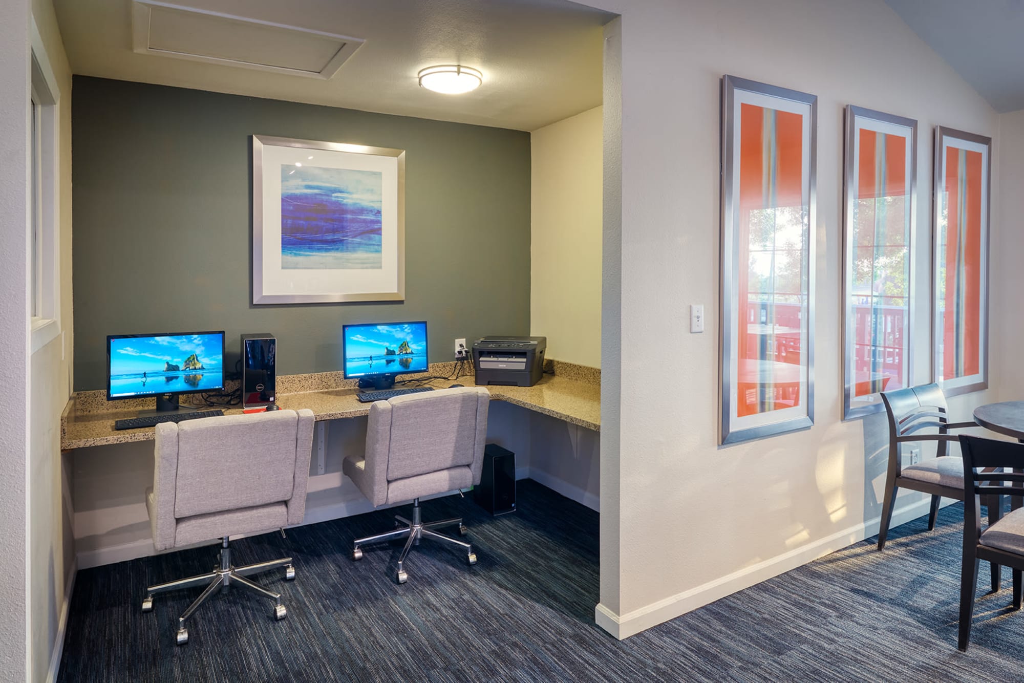 The business center in the clubhouse with computers for resident use at Bluesky Landing Apartments in Lakewood, Colorado