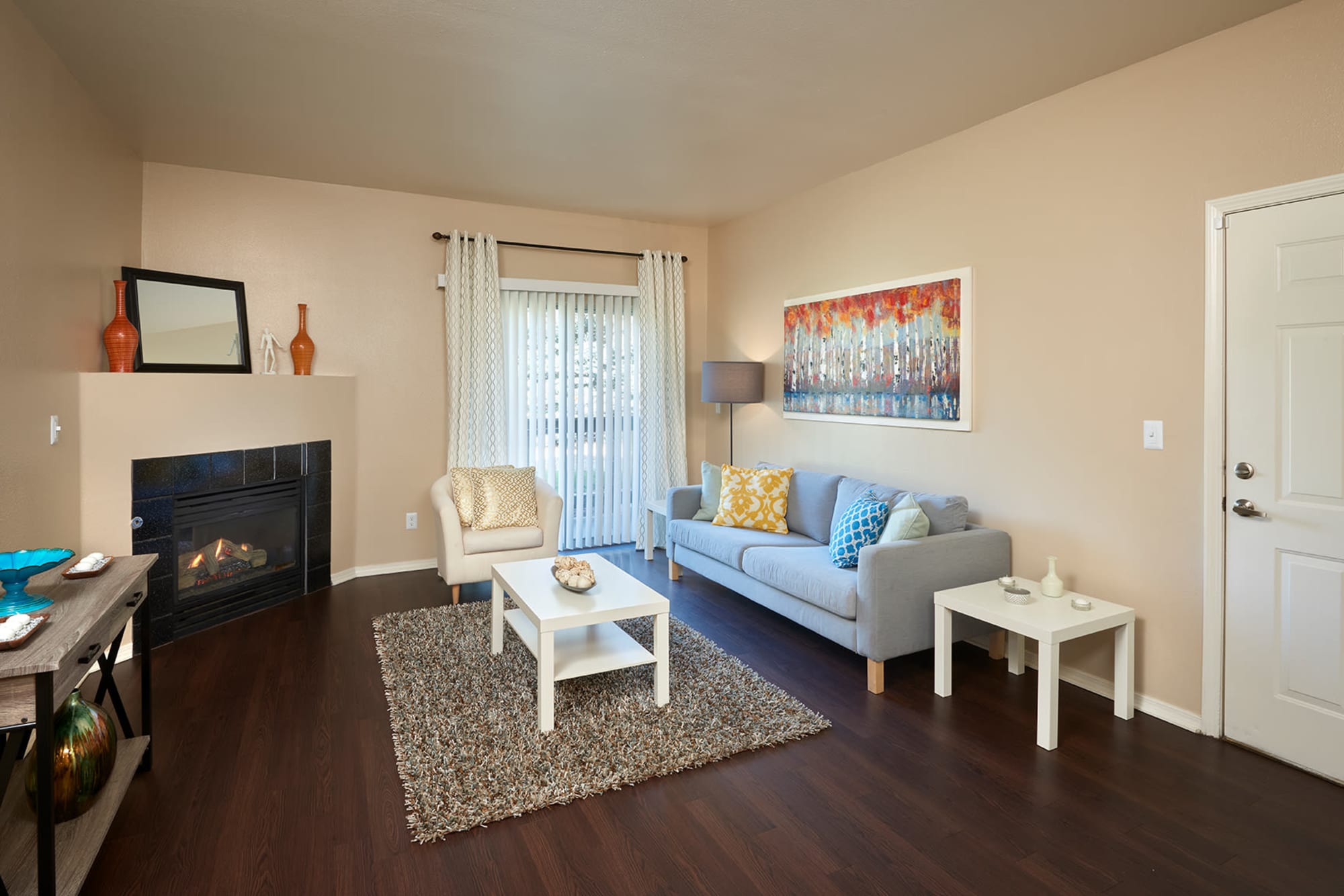 Living room with a fireplace at Crossroads at City Center Apartments in Aurora, Colorado