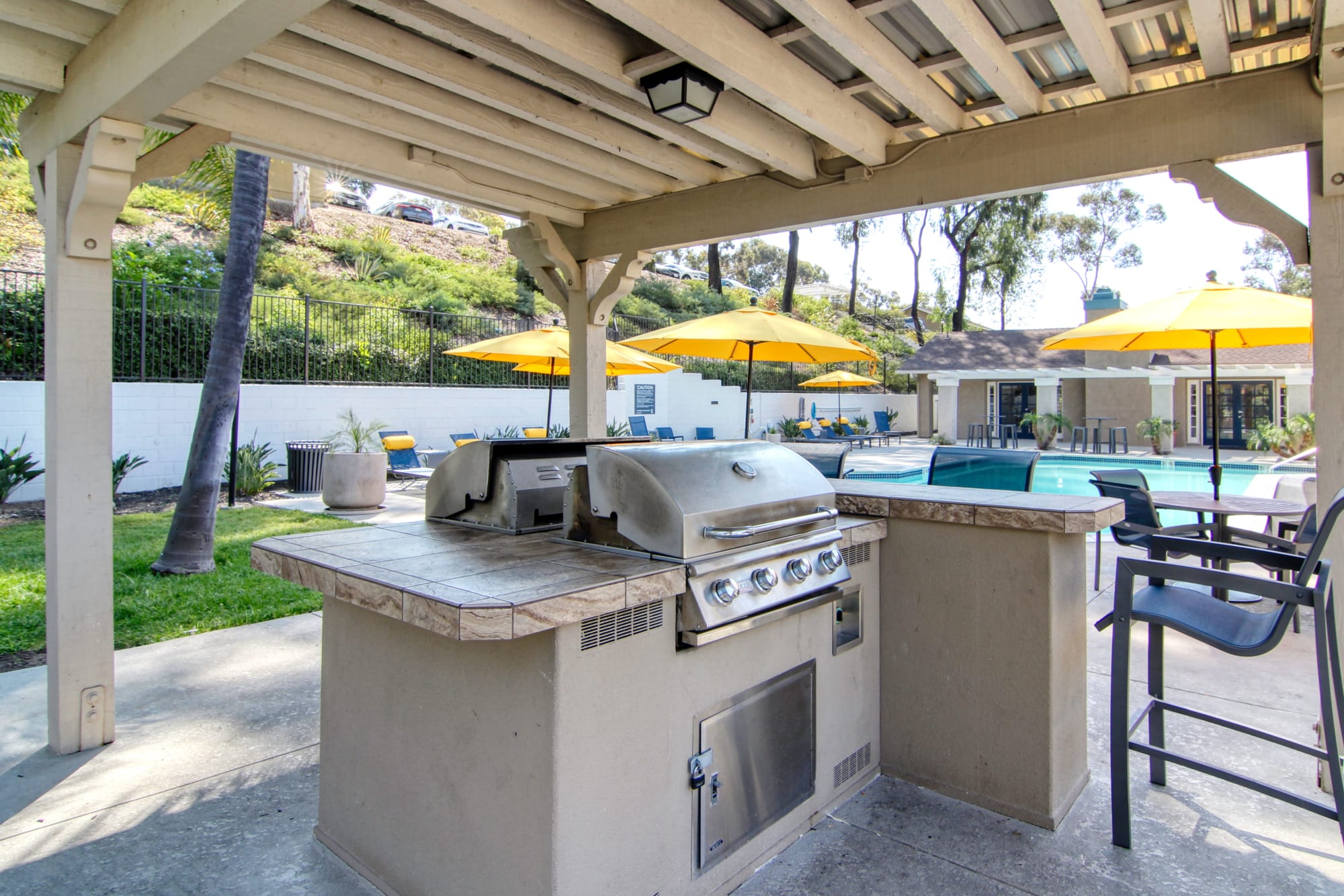 Covered poolside barbecue area at Lakeview Village Apartments in Spring Valley, California