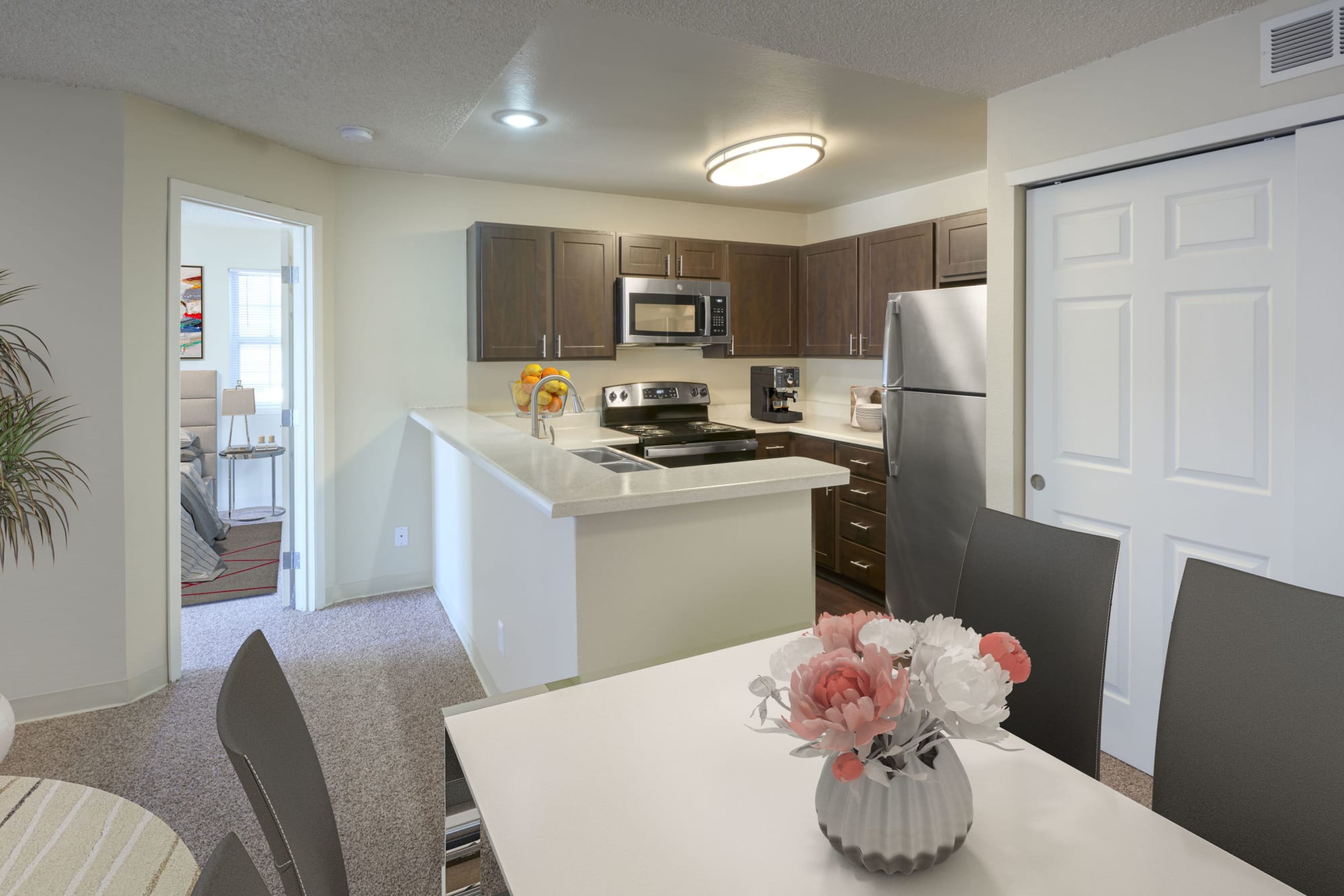 Kitchen overlooking the living room in an open floor plan at Bluesky Landing Apartments in Lakewood, Colorado