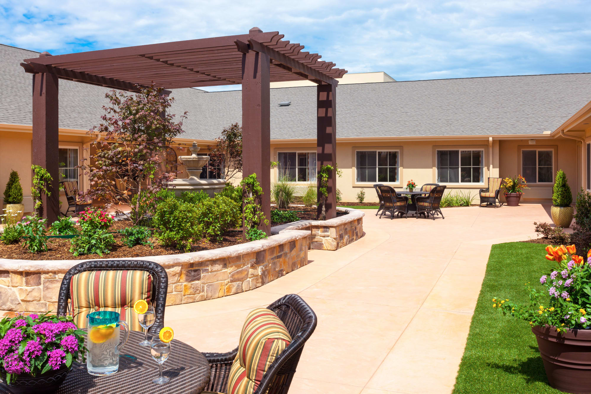 Paved patio with a community garden at Riverside Oxford Memory Care in Ft. Worth, Texas