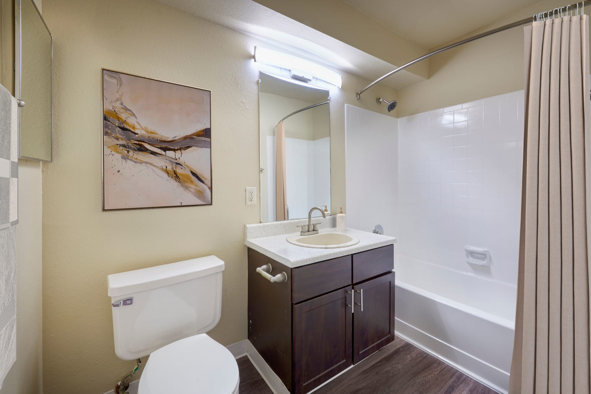 A model bathroom with espresso cabinets at Alton Green Apartments in Denver, Colorado
