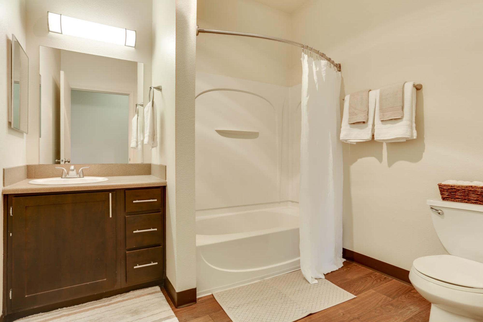 Spacious Brown Bathroom with Tub at The Landings at Morrison Apartments in Gresham, Oregon