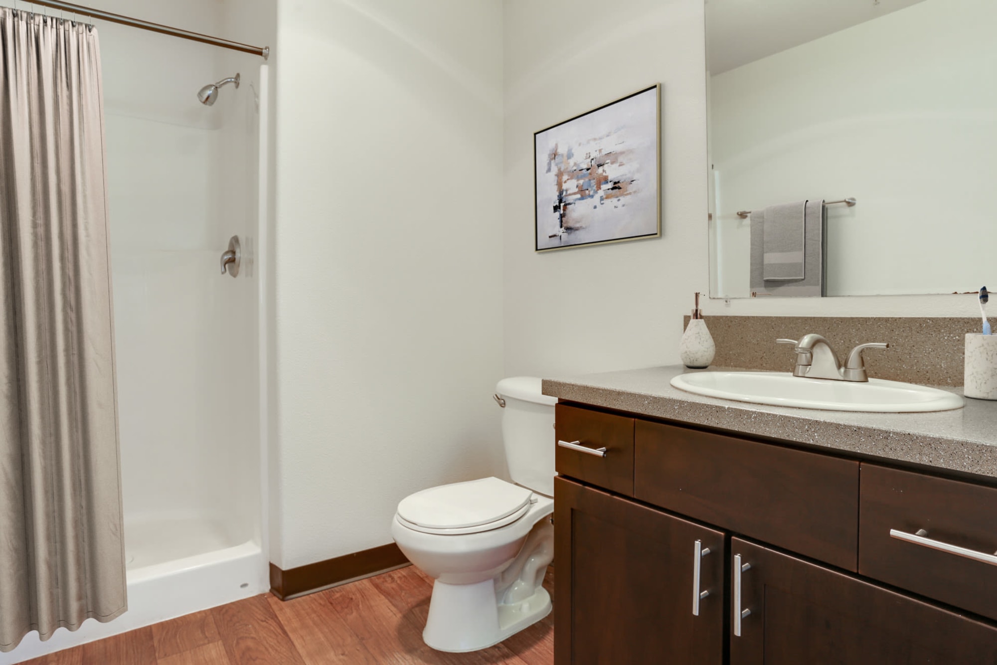 Renovated bathroom with brown cabinets at The Addison Apartments in Vancouver, Washington