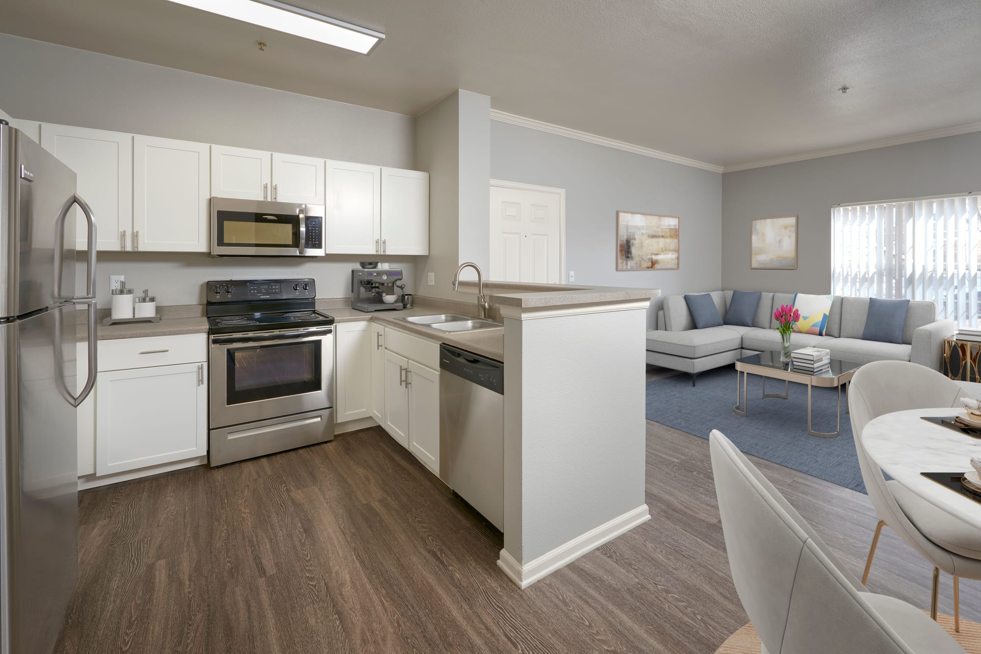 Newly renovated home with white kitchen cabinetry and stainless steel appliances at Westridge Apartments in Aurora, Colorado