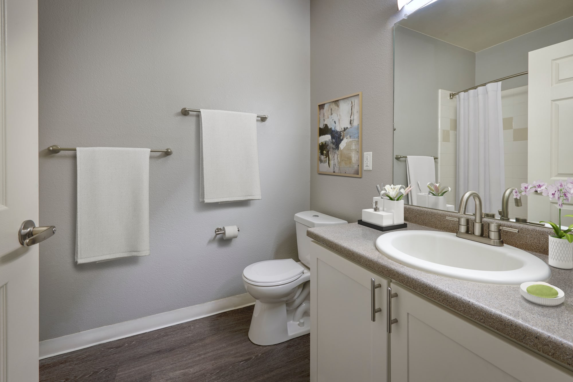 Bathroom with white cabinets and a tub at Westridge Apartments in Aurora, Colorado