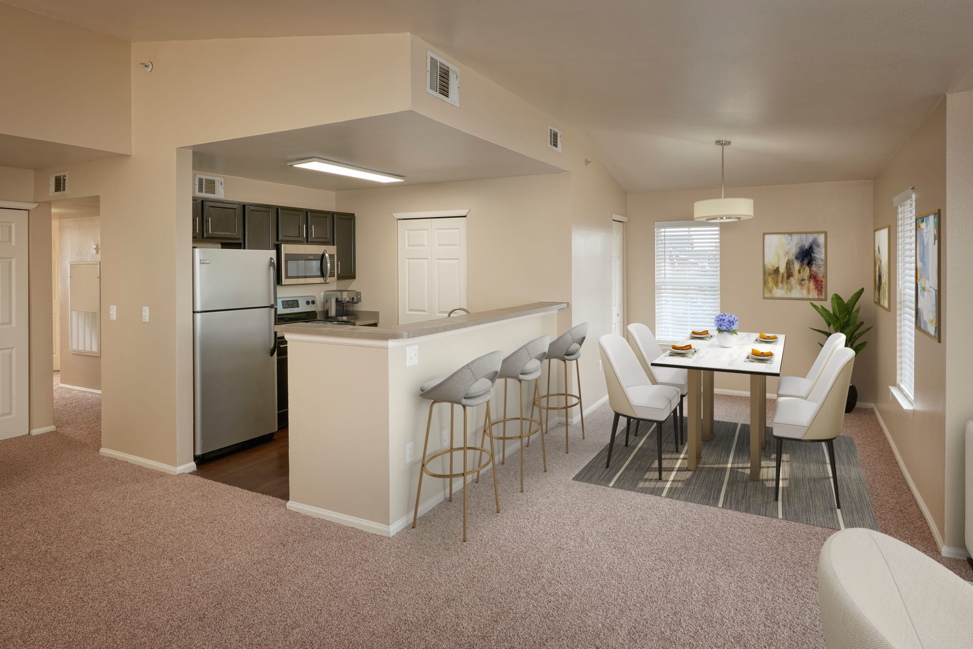 Newly renovated home with white brown cabinetry and stainless steel appliances at Westridge Apartments in Aurora, Colorado
