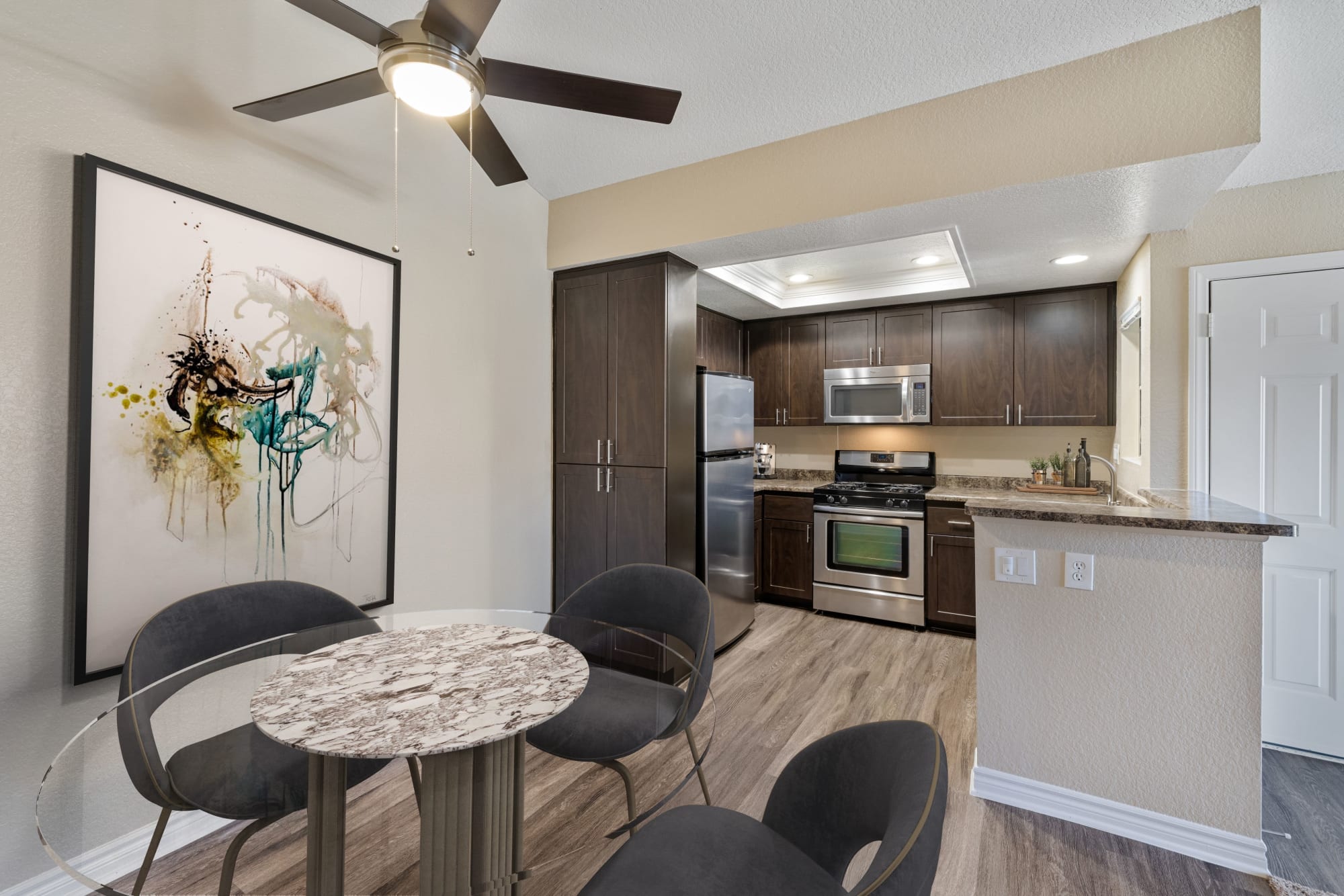 Renovated kitchen with brown cabinets at Village Oaks in Chino Hills, California