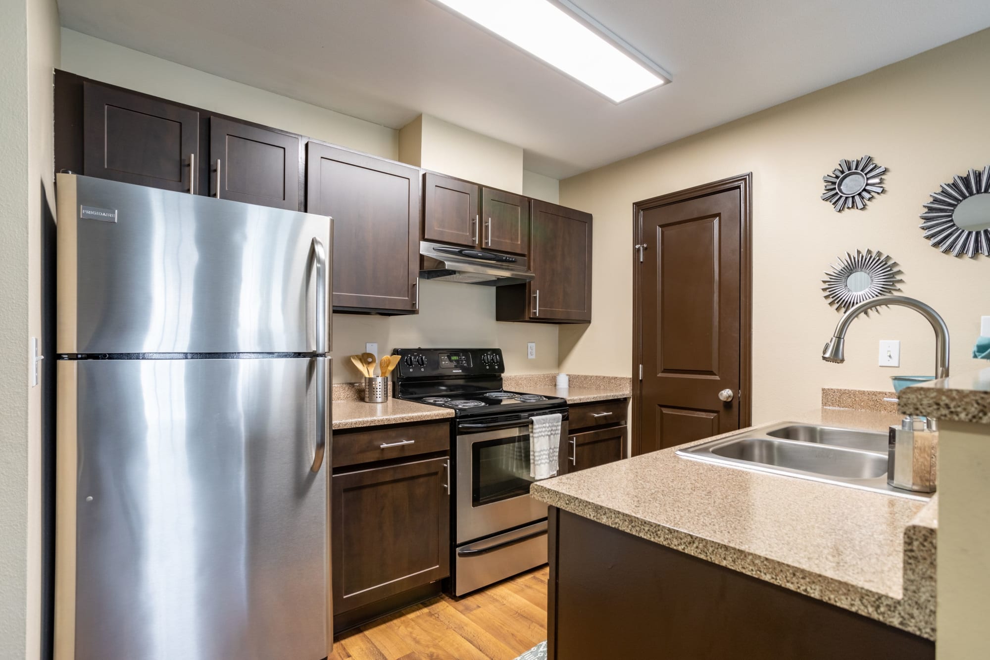 Renovated kitchen with stainless steel appliances at Pebble Cove Apartments in Renton, Washington