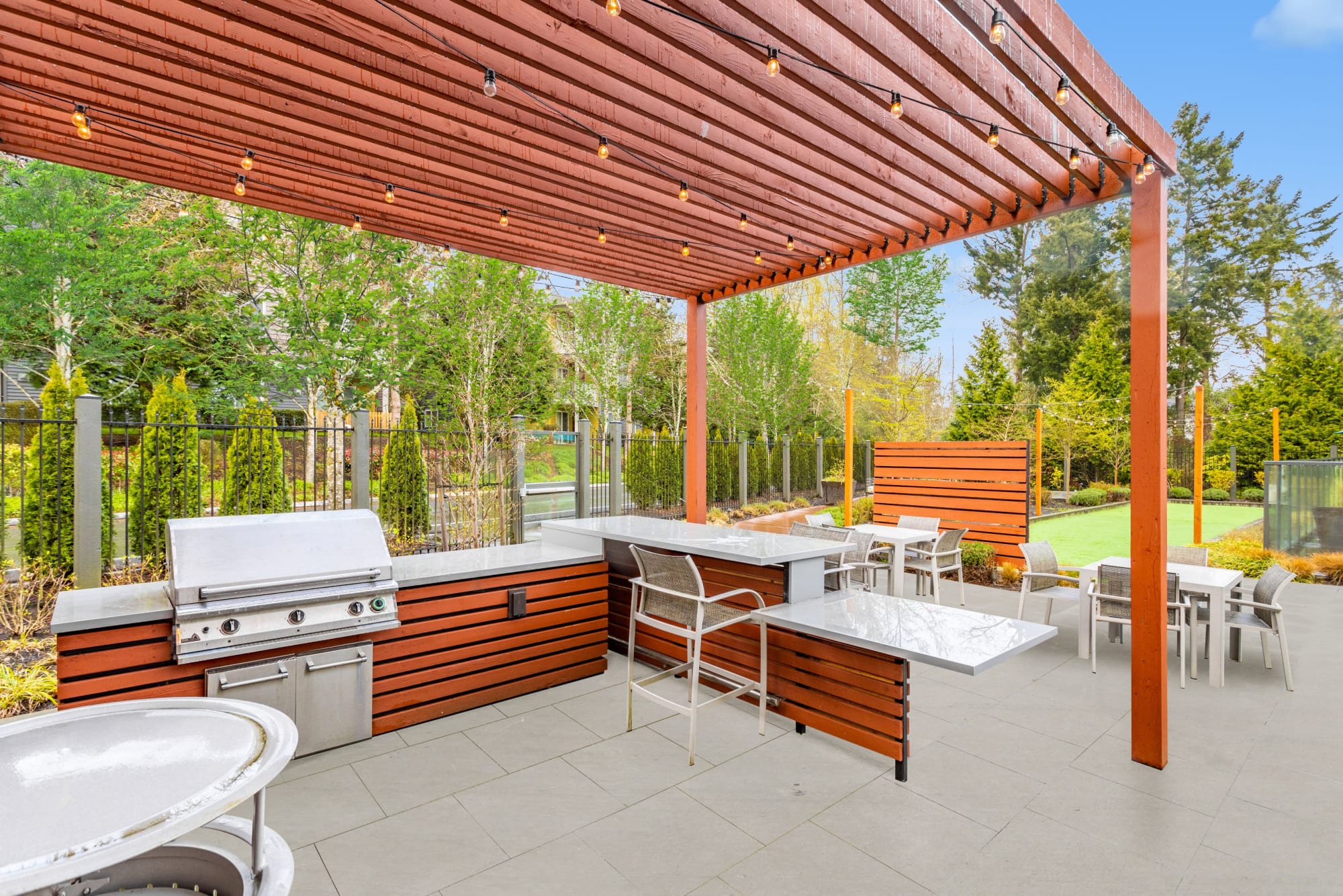 A grilling area and dining tables at Brookside Village in Auburn, Washington