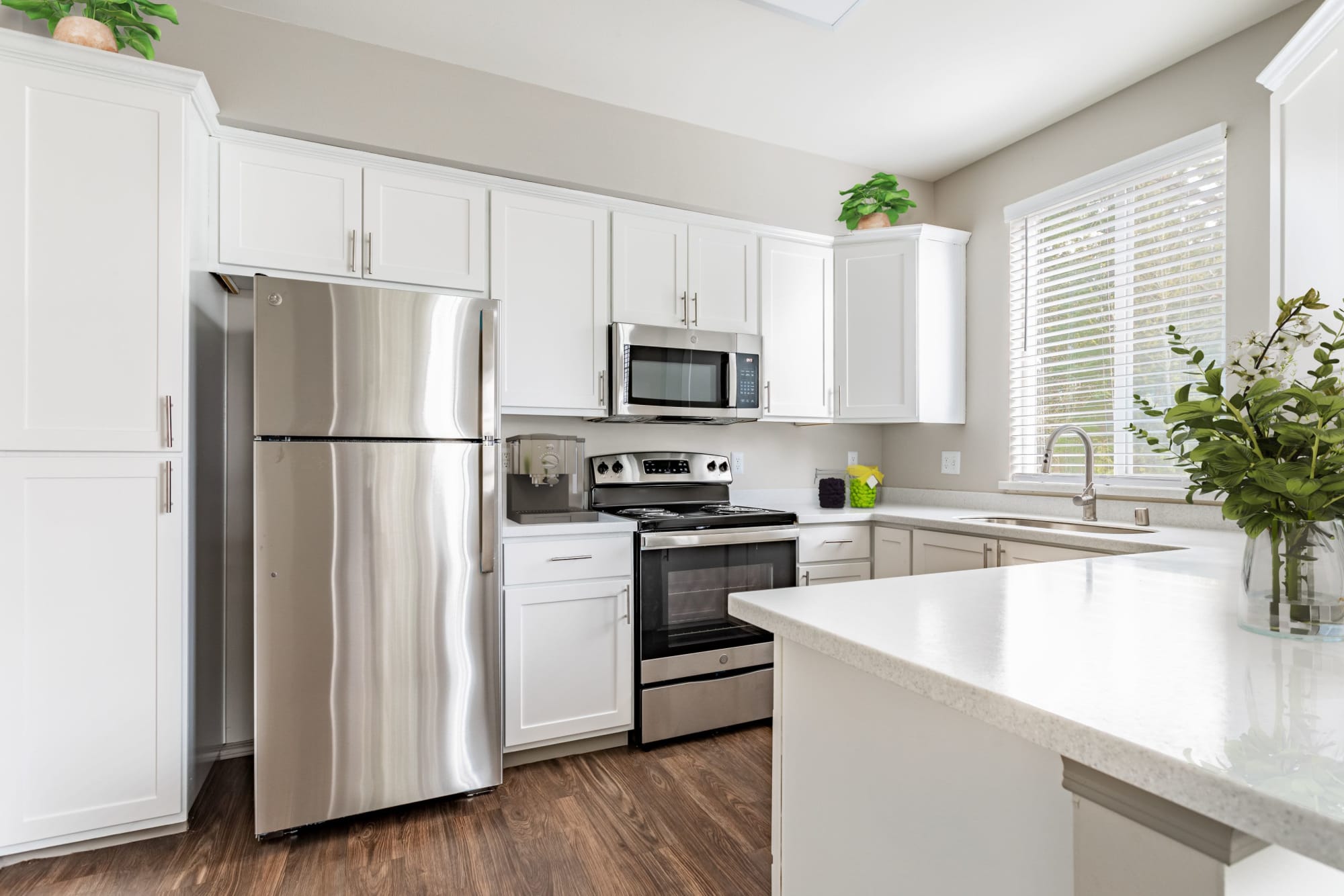 Renovated kitchen with white cabinets at Brookside Village in Auburn, Washington