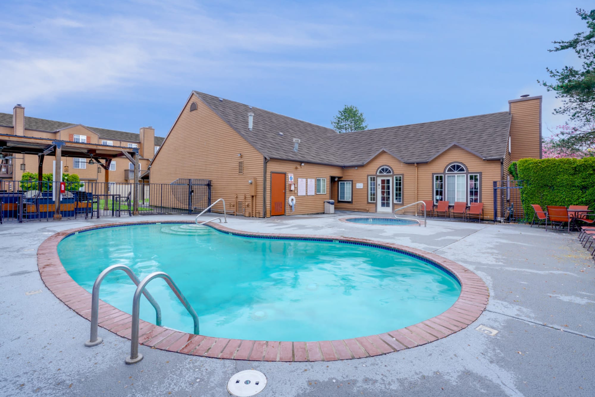 Sparkling pool with lounge chairs at Renaissance at 29th Apartments in Vancouver, Washington