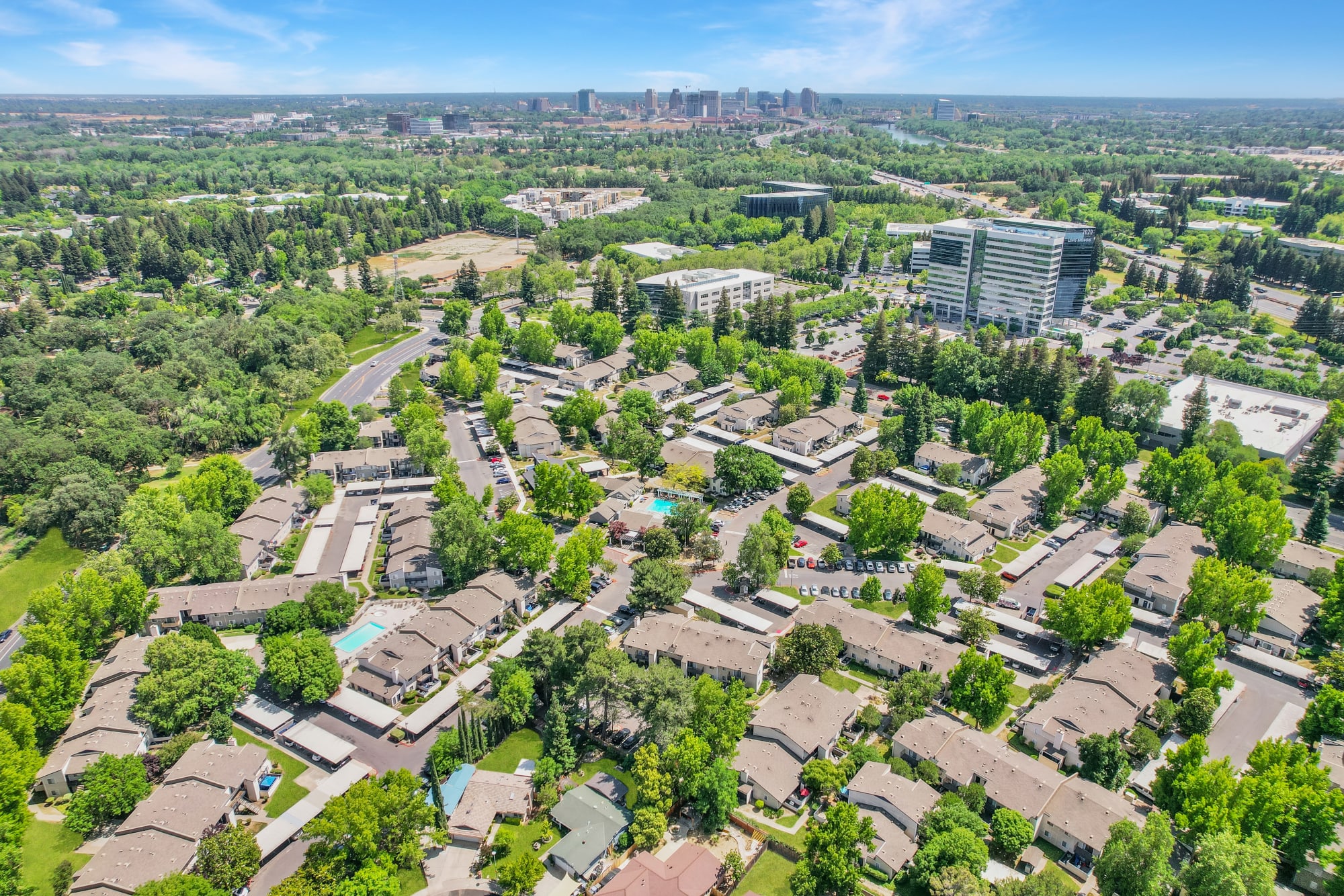 Aerial view of the property and surrounding area at The Woodlands Apartments in Sacramento, California