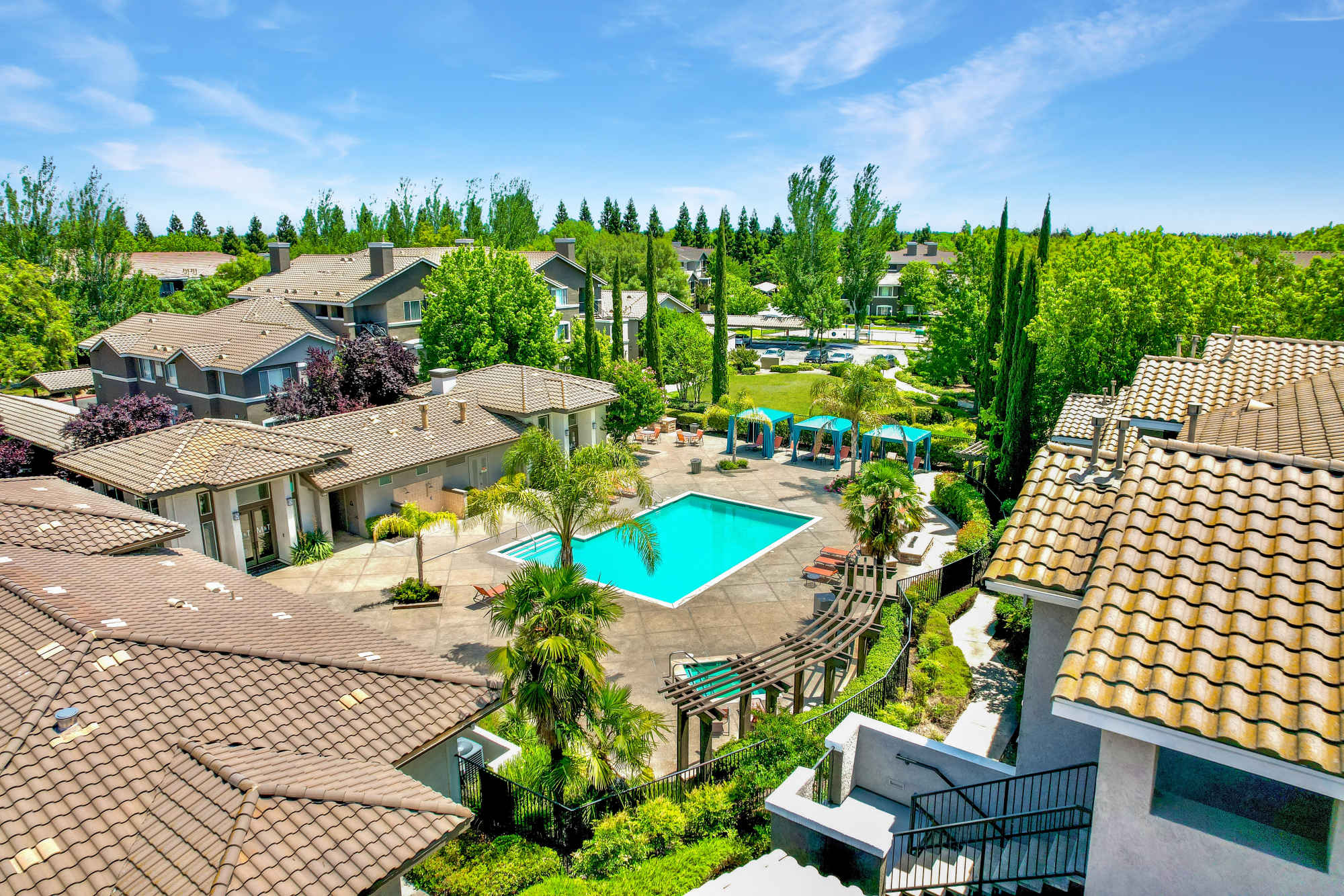Aerial view of the resort-style swimming pool and clubhouse at Miramonte and Trovas in Sacramento, California