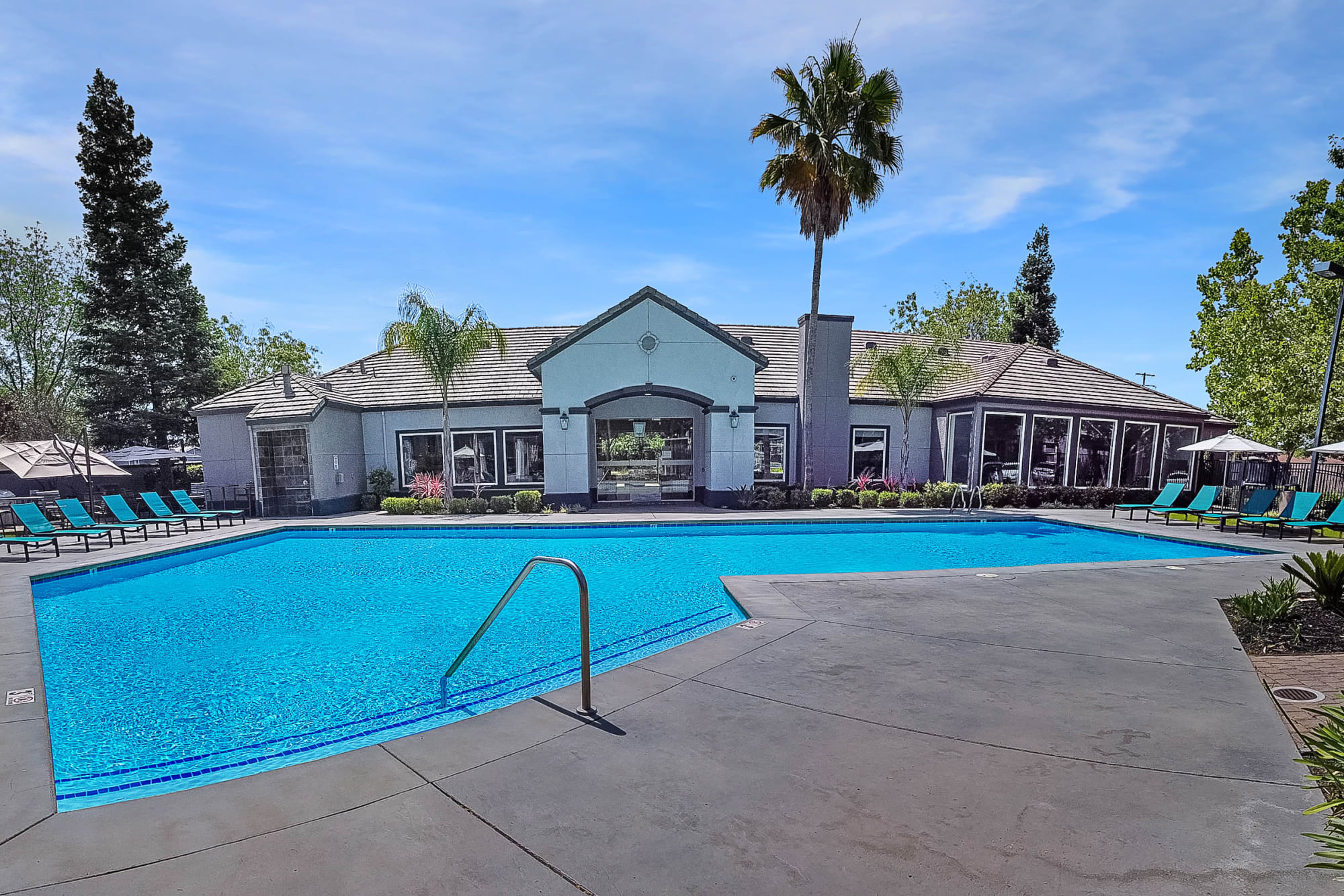 Swimming pool and patio seating at Avion Apartments in Rancho Cordova, California