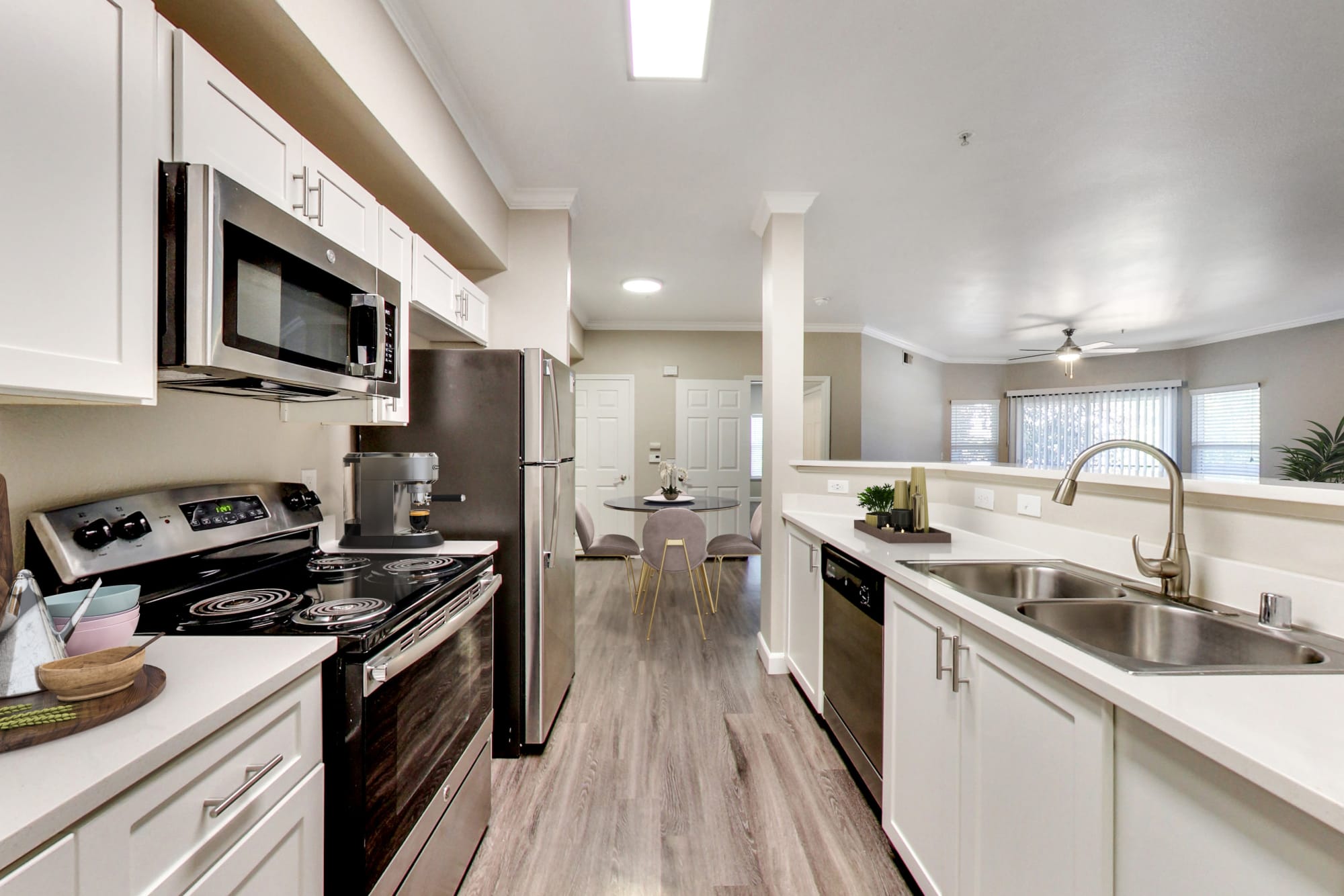 A modern apartment kitchen with white cabinetry at Avion Apartments in Rancho Cordova, California
