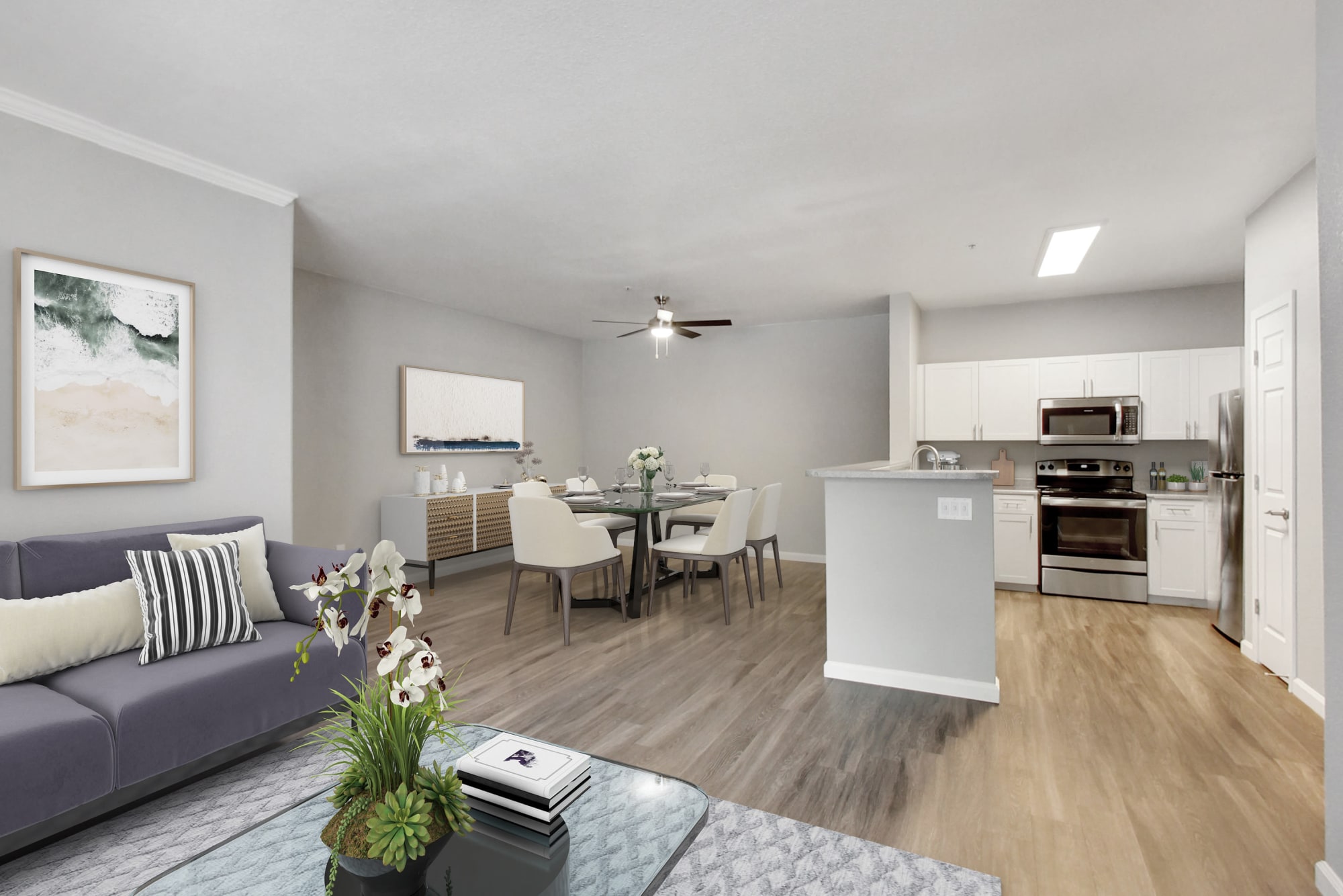 A full renovated white kitchen and spacious living and dining room at Natomas Park Apartments in Sacramento, California