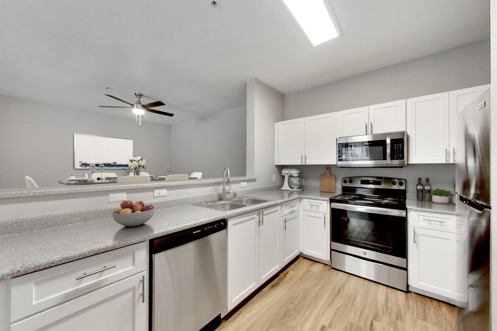 A full renovated white kitchen at Natomas Park Apartments in Sacramento, California