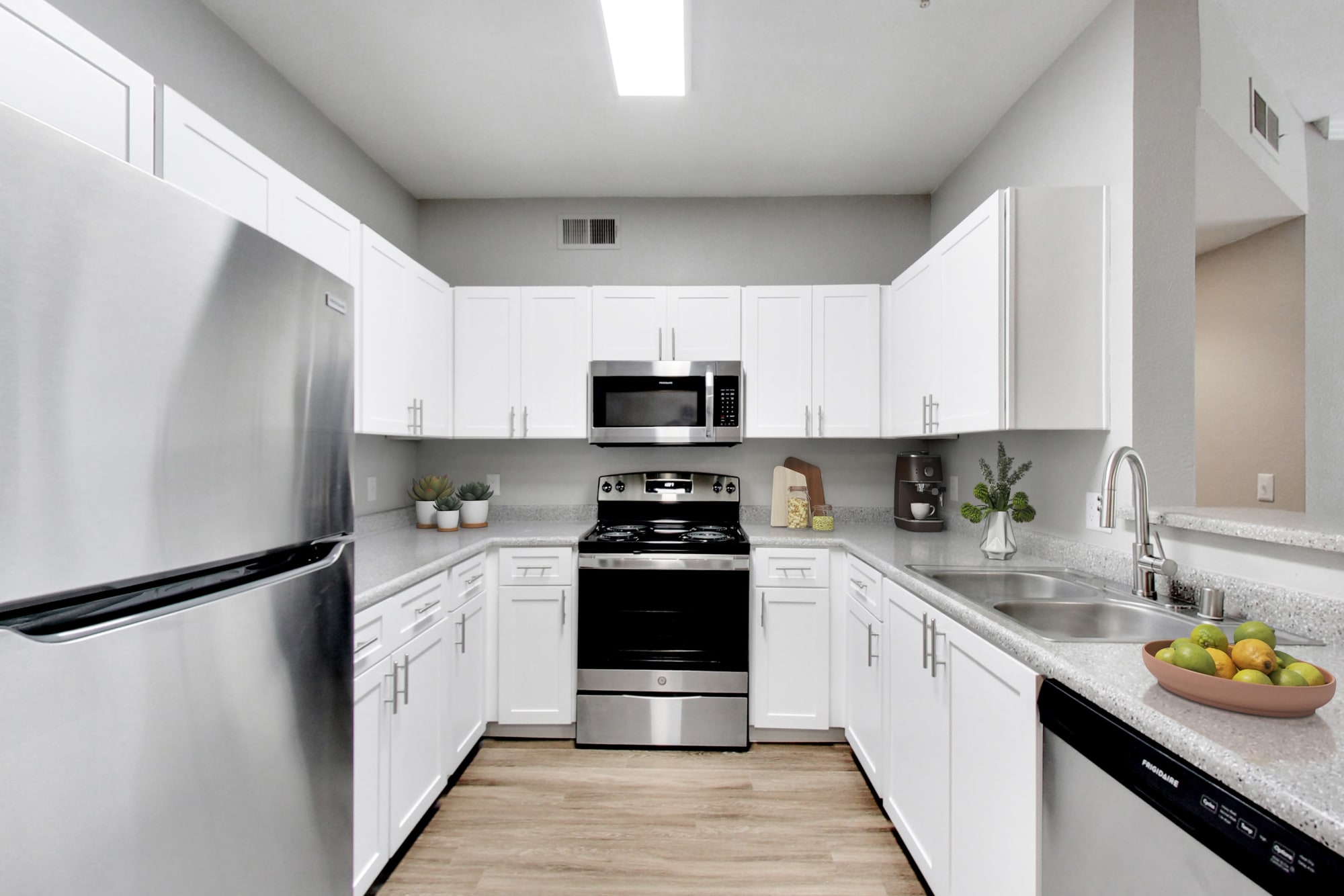 Beautiful renovated kitchen with white cabinetry at Natomas Park Apartments in Sacramento, California