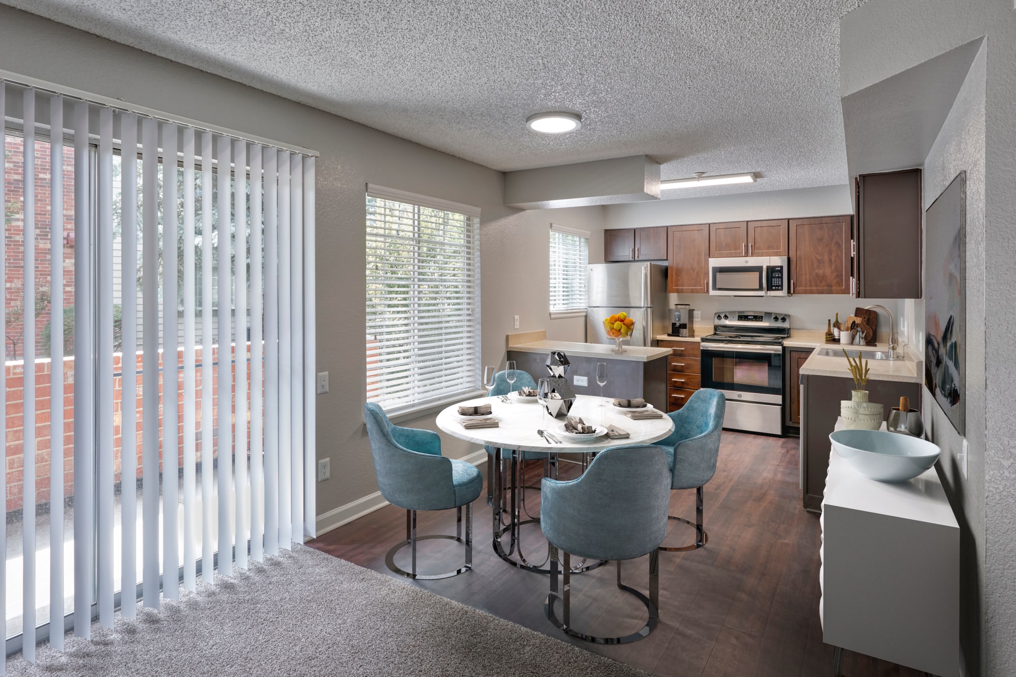 Kitchen overlooking the dining room in an open floor plan at Arapahoe Club Apartments in Denver, Colorado
