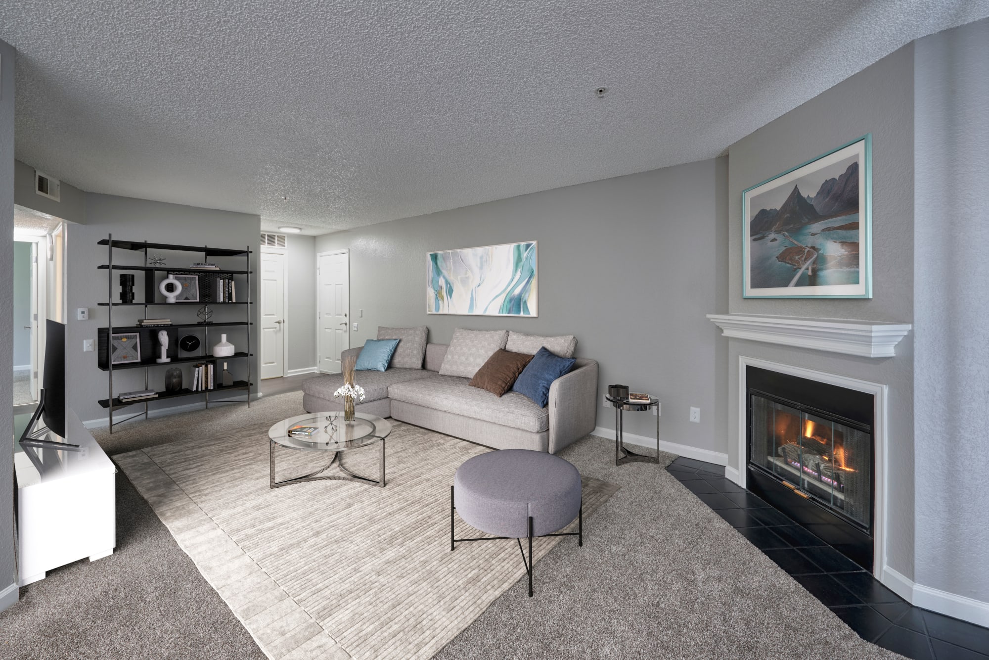 A spacious living room filled with sunlight at Arapahoe Club Apartments in Denver, Colorado
