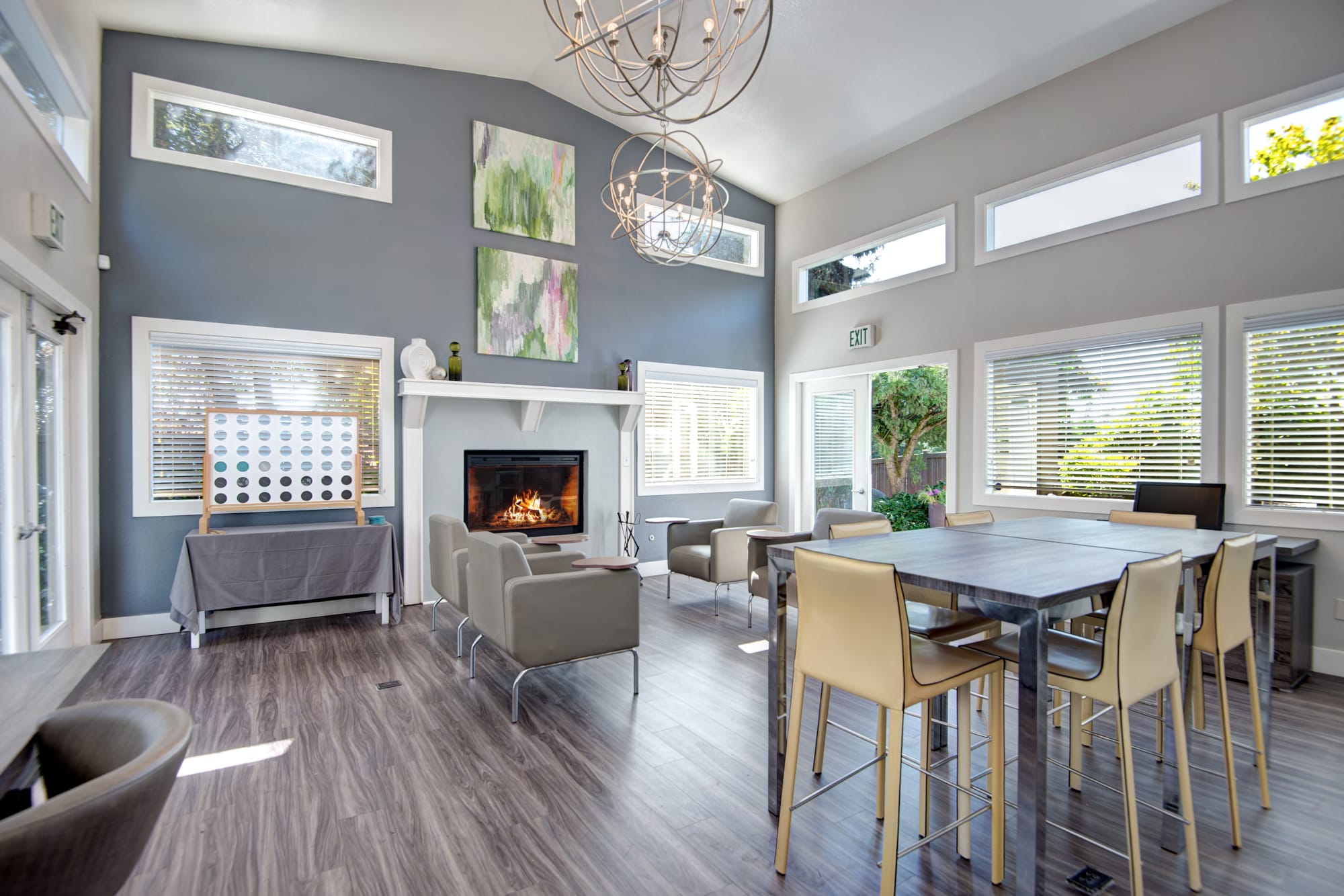 Clubhouse with a fireplace and lounge area at Latitude Apartments in Everett, Washington