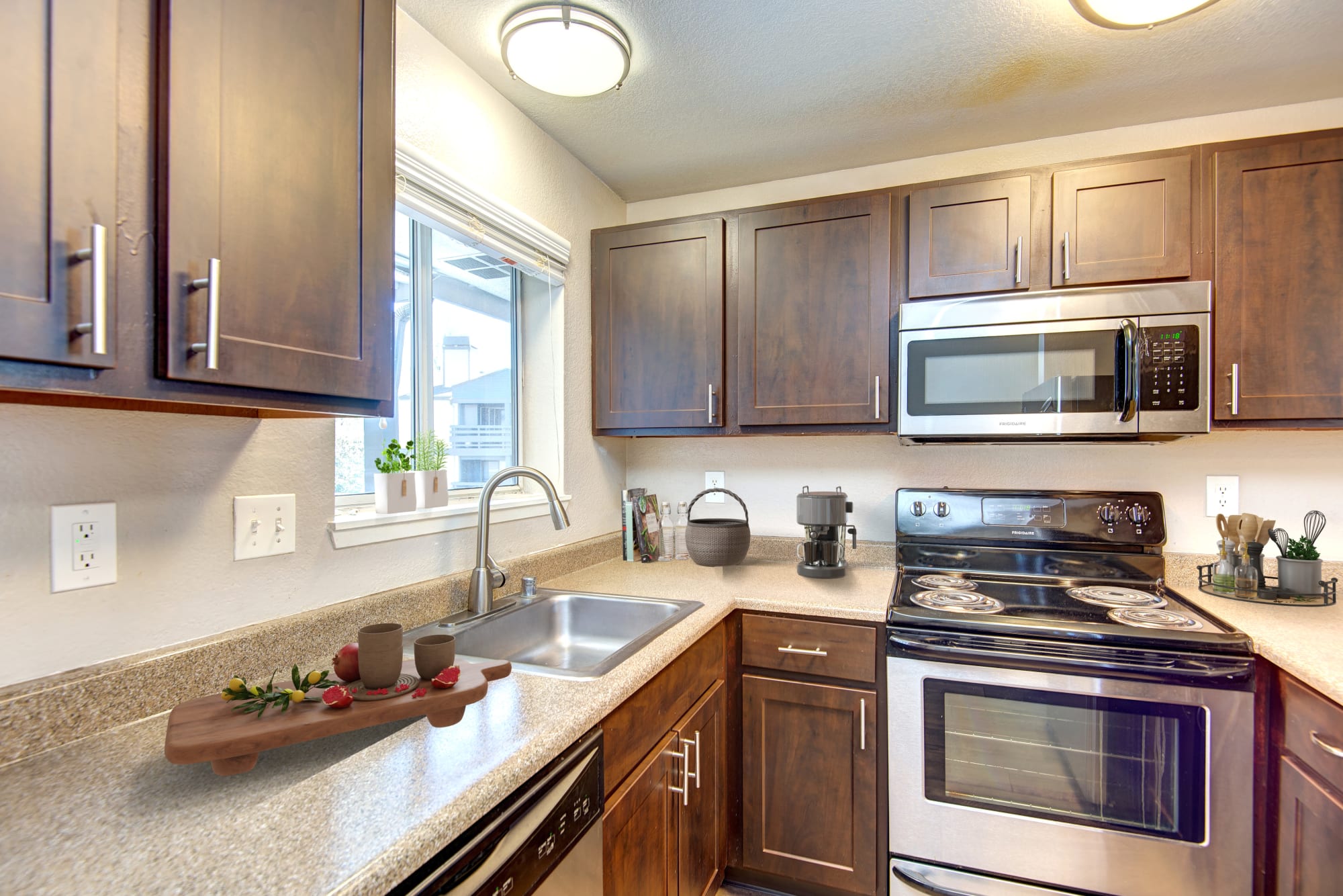 Espresso renovated kitchen with stainless steel appliances at Latitude Apartments in Everett, Washington