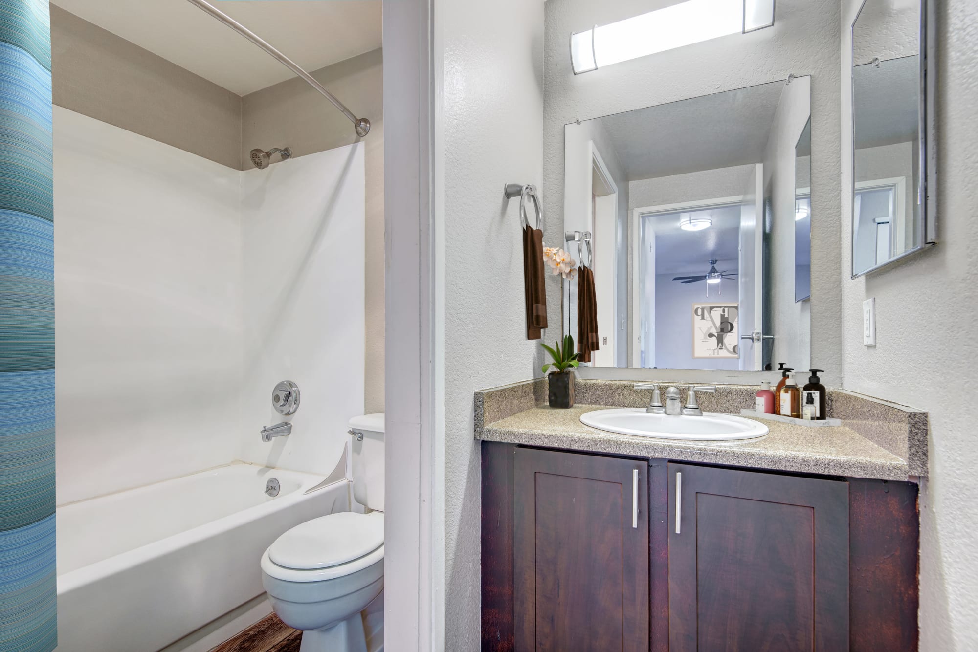 Brown renovated bathroom with a tub at Latitude Apartments in Everett, Washington