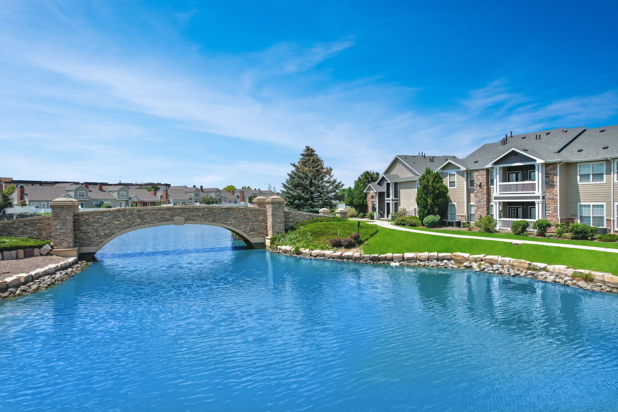 Lake and Exterior Building View with Bridge over Lake of Gateway Park Apartments in Denver, Colorado