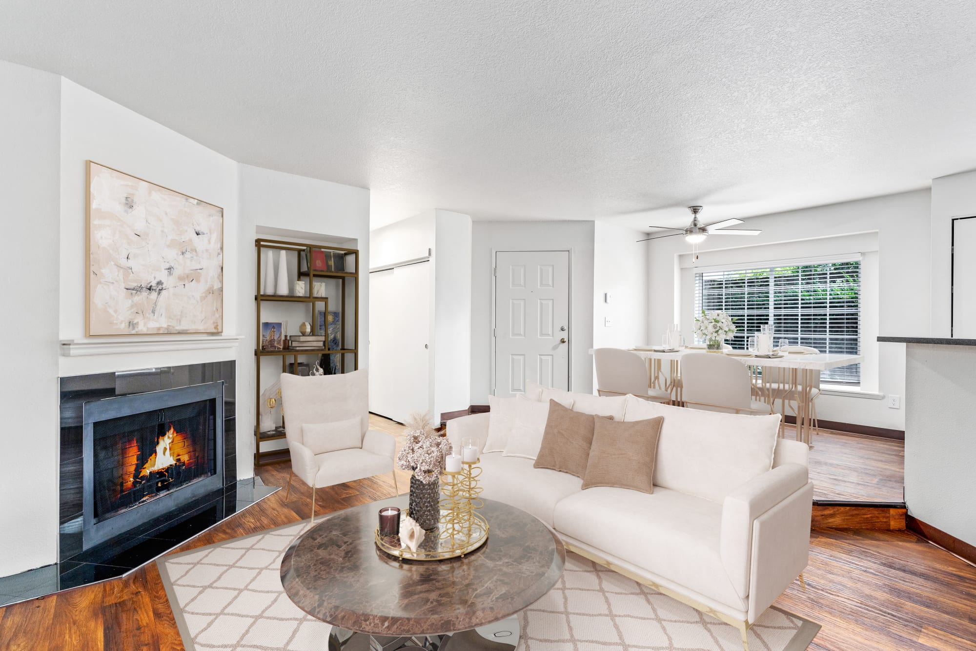 Bright and open living room with a fireplace at Autumn Chase Apartments in Vancouver, Washington