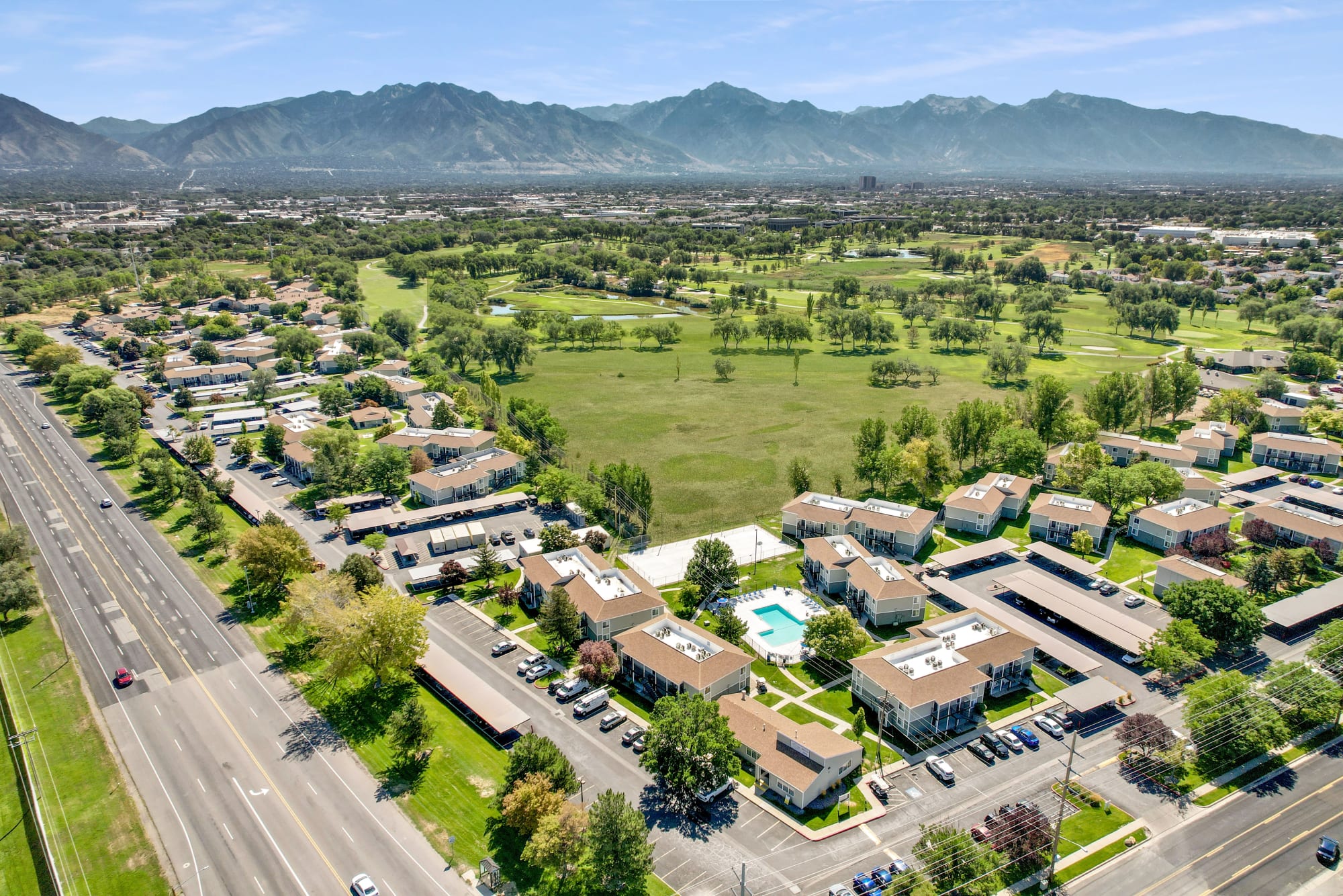 Aerial view of property and surrounding area including a golf course next door at Callaway Apartments in Taylorsville, Utah 